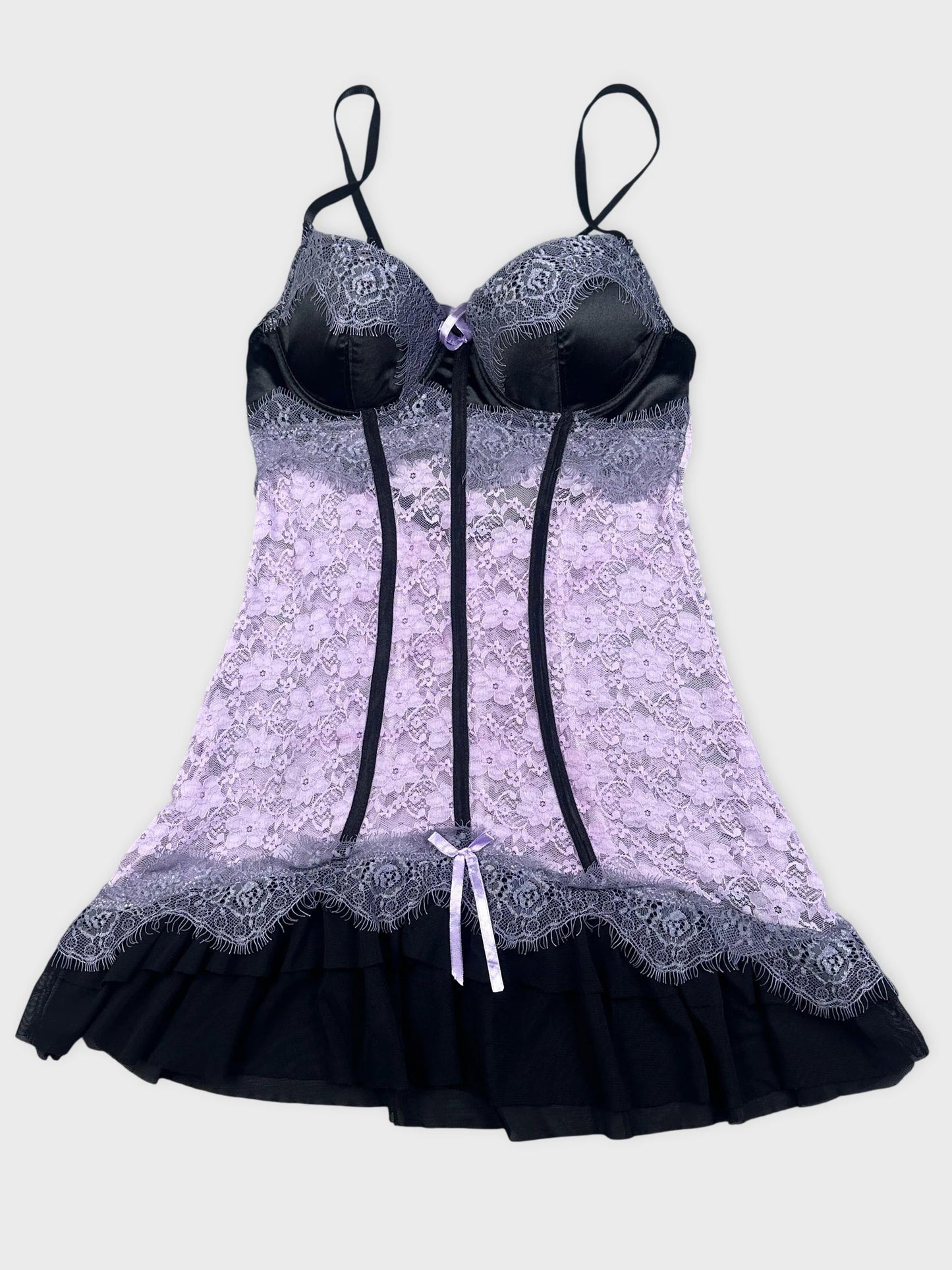Detail view of lace corset in lavender and black with frilled hem