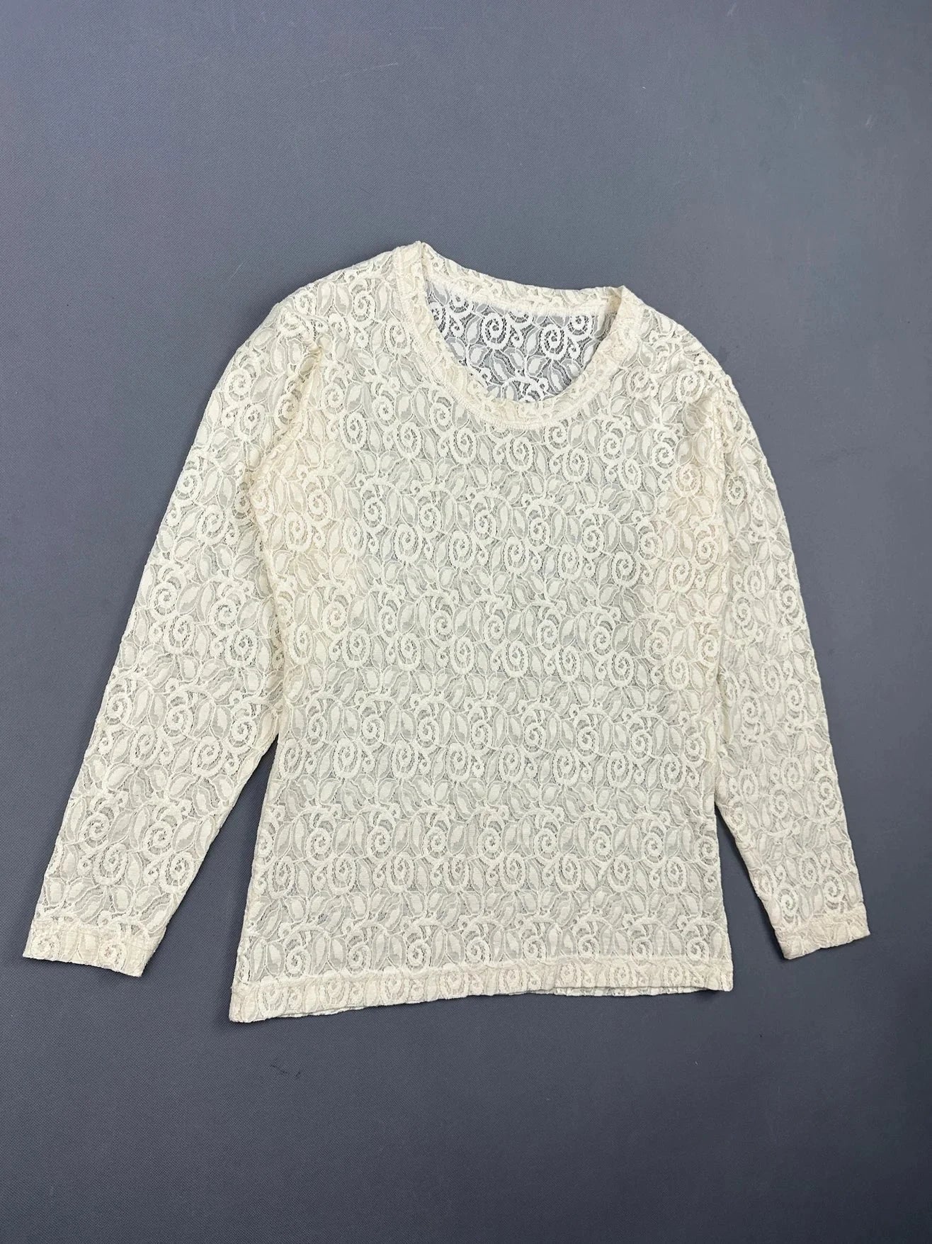 Lace long sleeve top in cream with floral detail, detail view.