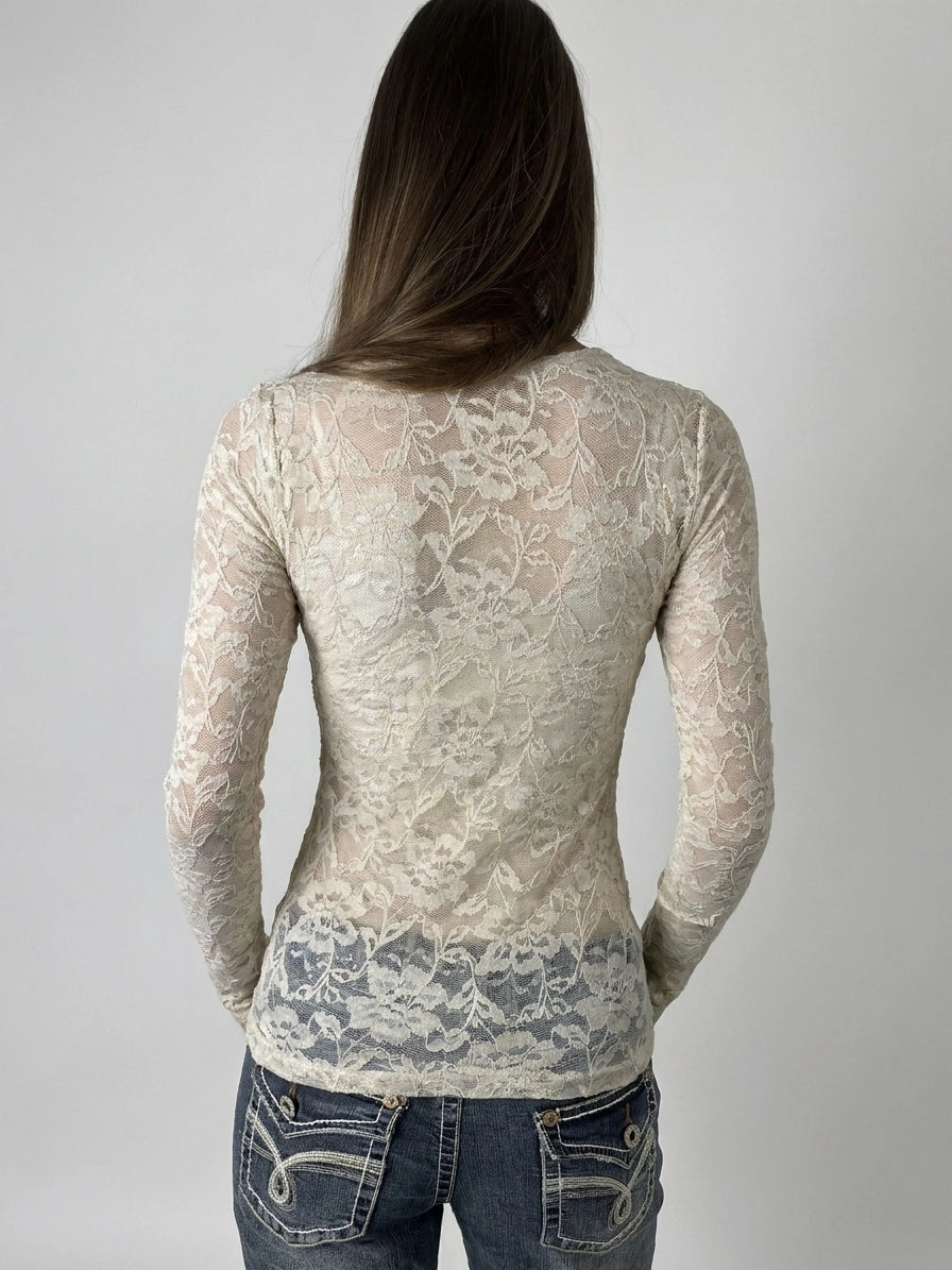 Lace long sleeve top in cream color with sheer detail, back view.