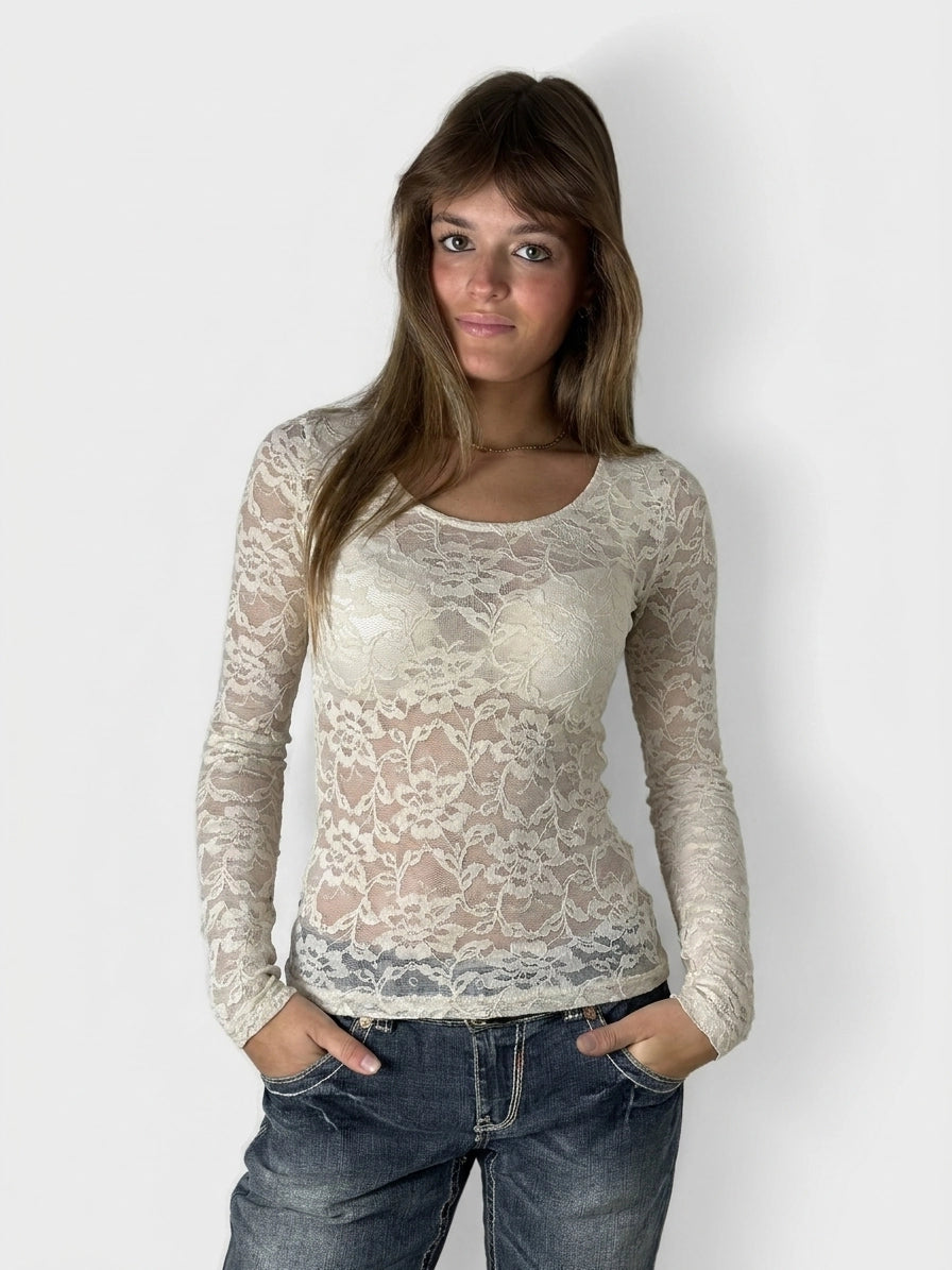 Lace long sleeve top in cream color with floral pattern, front view.