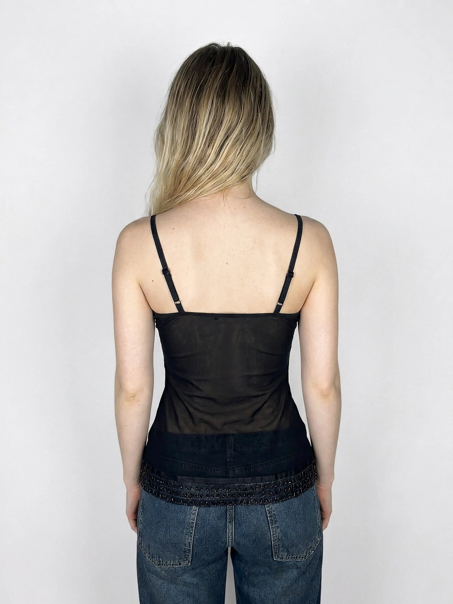 Back view of a black camisole top with lace trim detail.