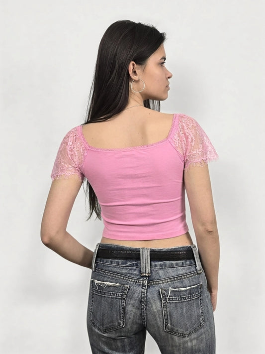 Back view of a pink crop top featuring lace trim on sleeves.
