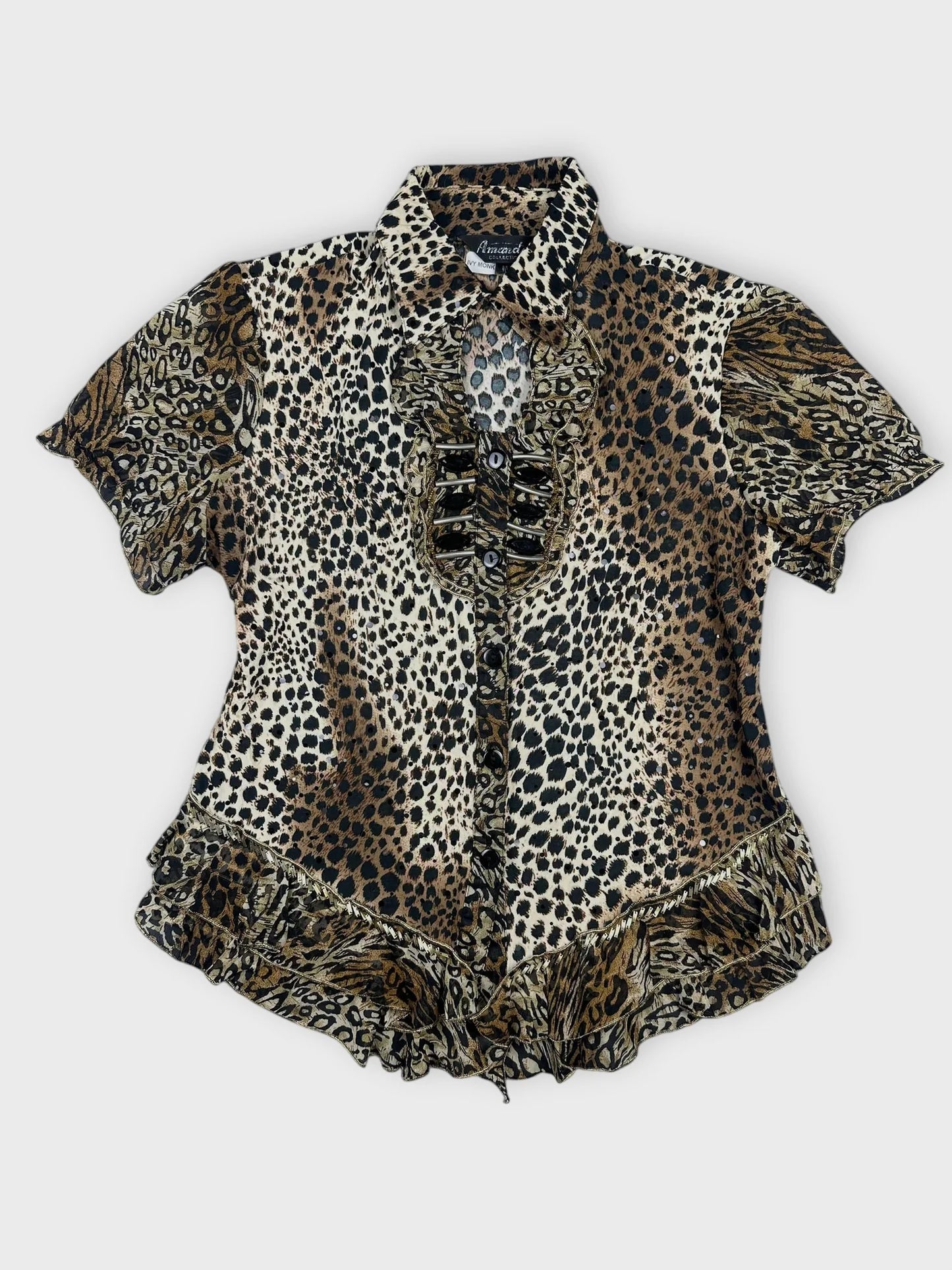 Front view of leopard print button-up top with ruffled hem and sleeves.