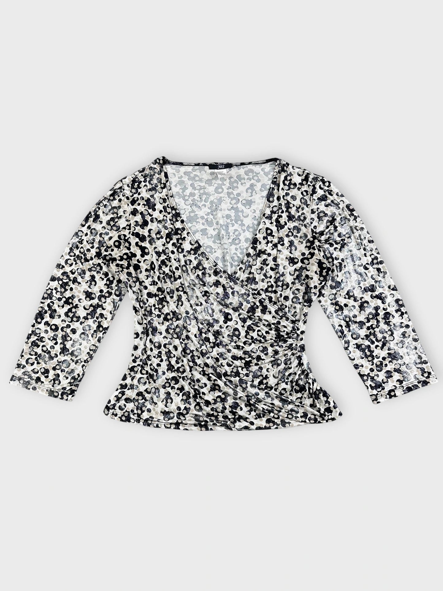 Detail view of leopard print long sleeve top featuring a V-neck design.
