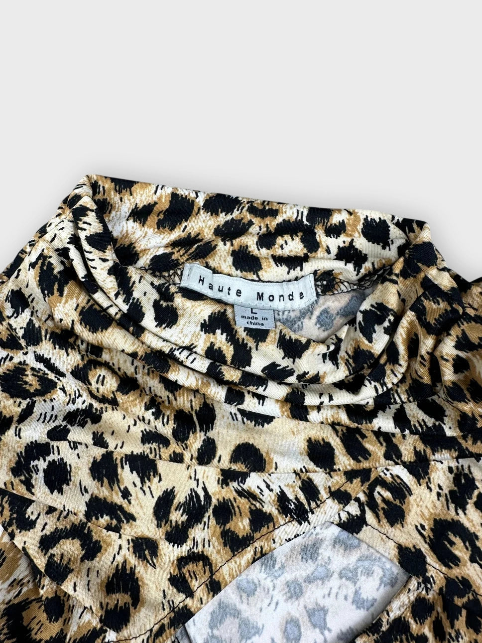 Leopard print long sleeve top detail view featuring a cutout neckline.
