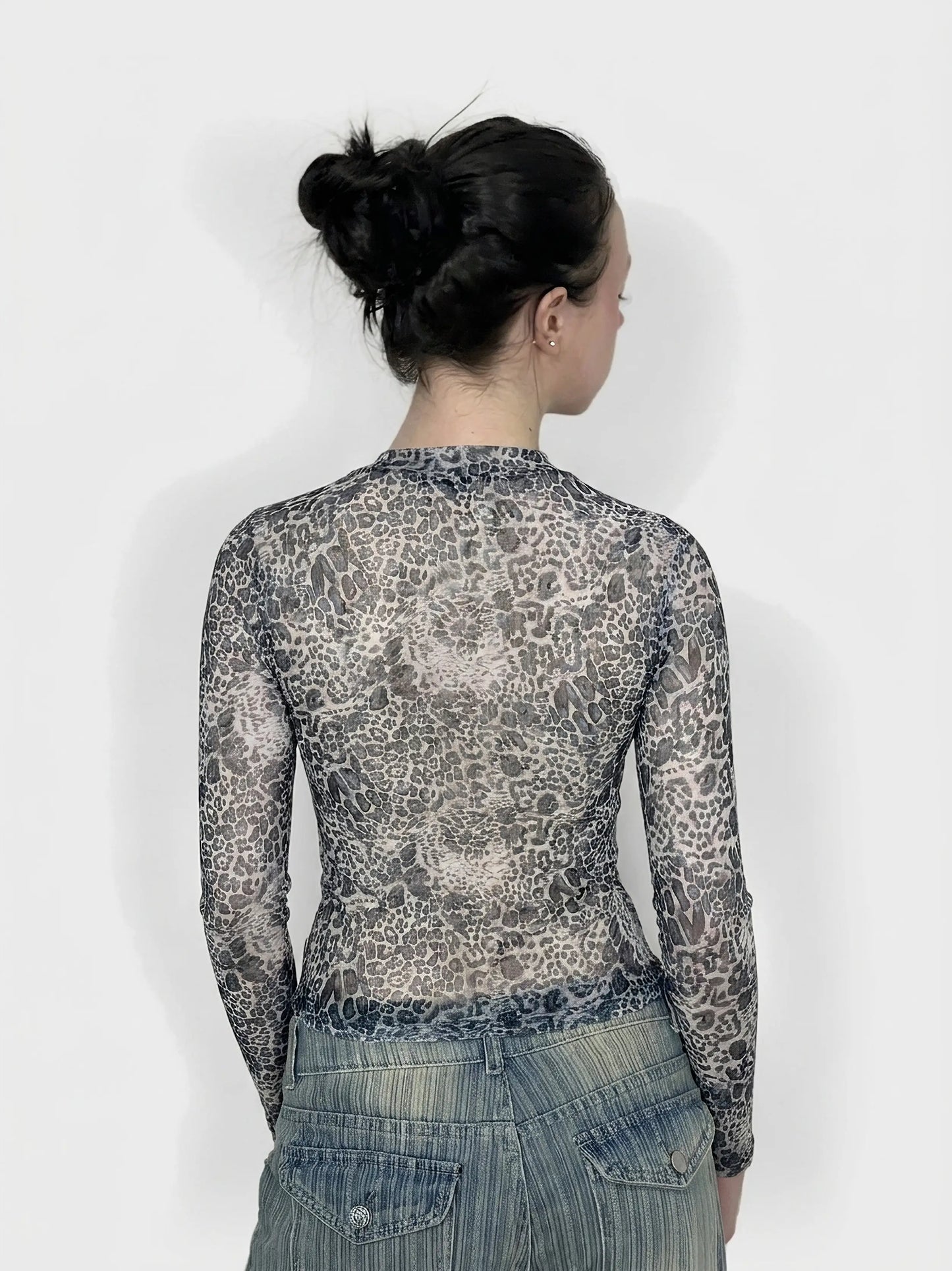Back view of a leopard print mesh top with long sleeves.