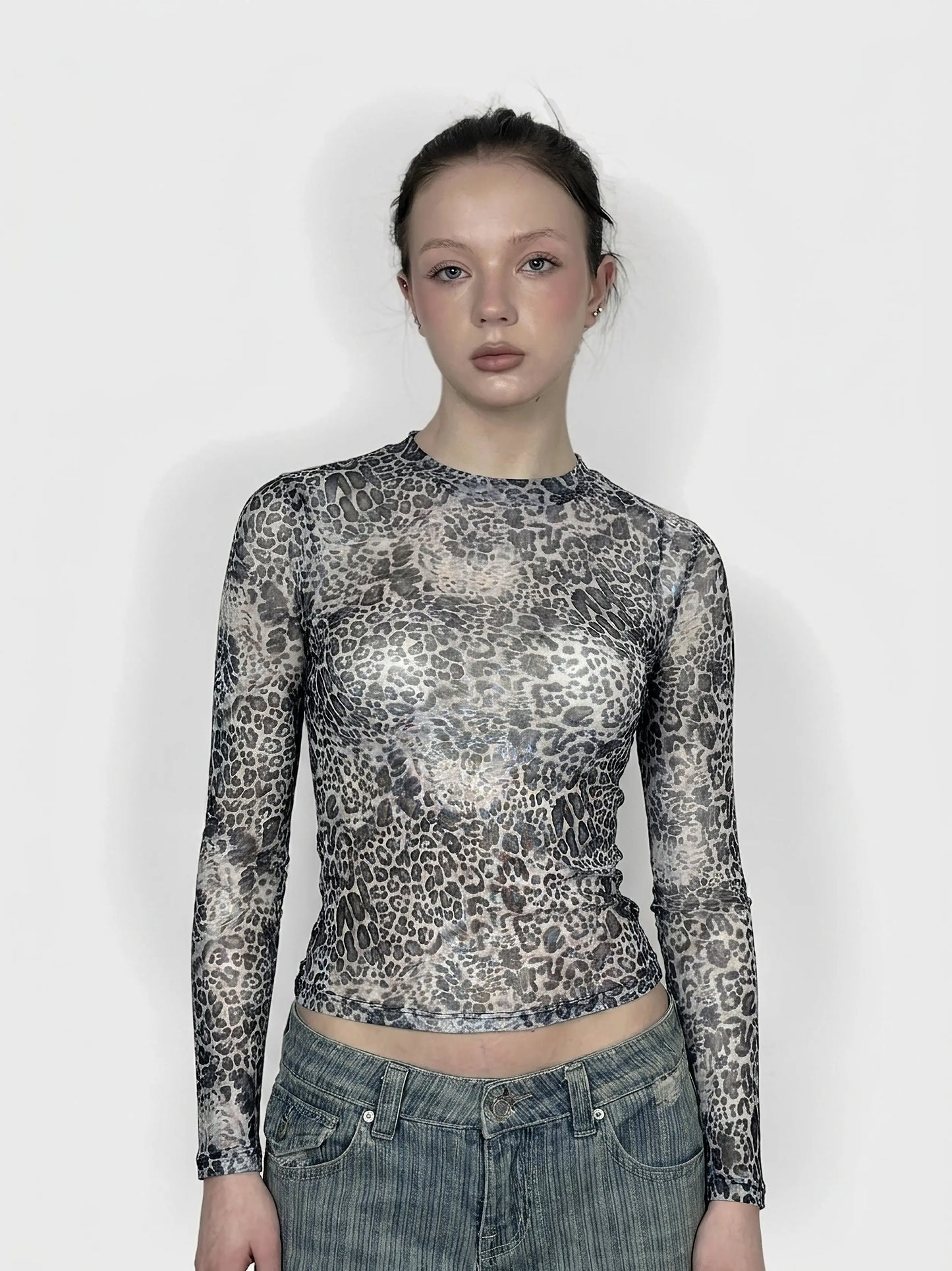 Front view of a leopard print mesh top with long sleeves.