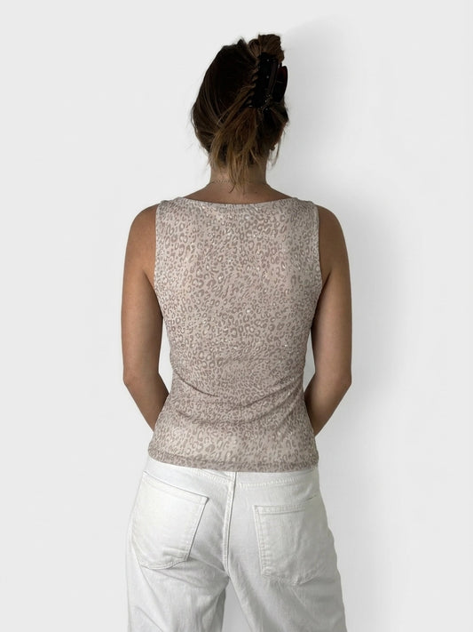 Back view of a light brown leopard print short sleeve top.