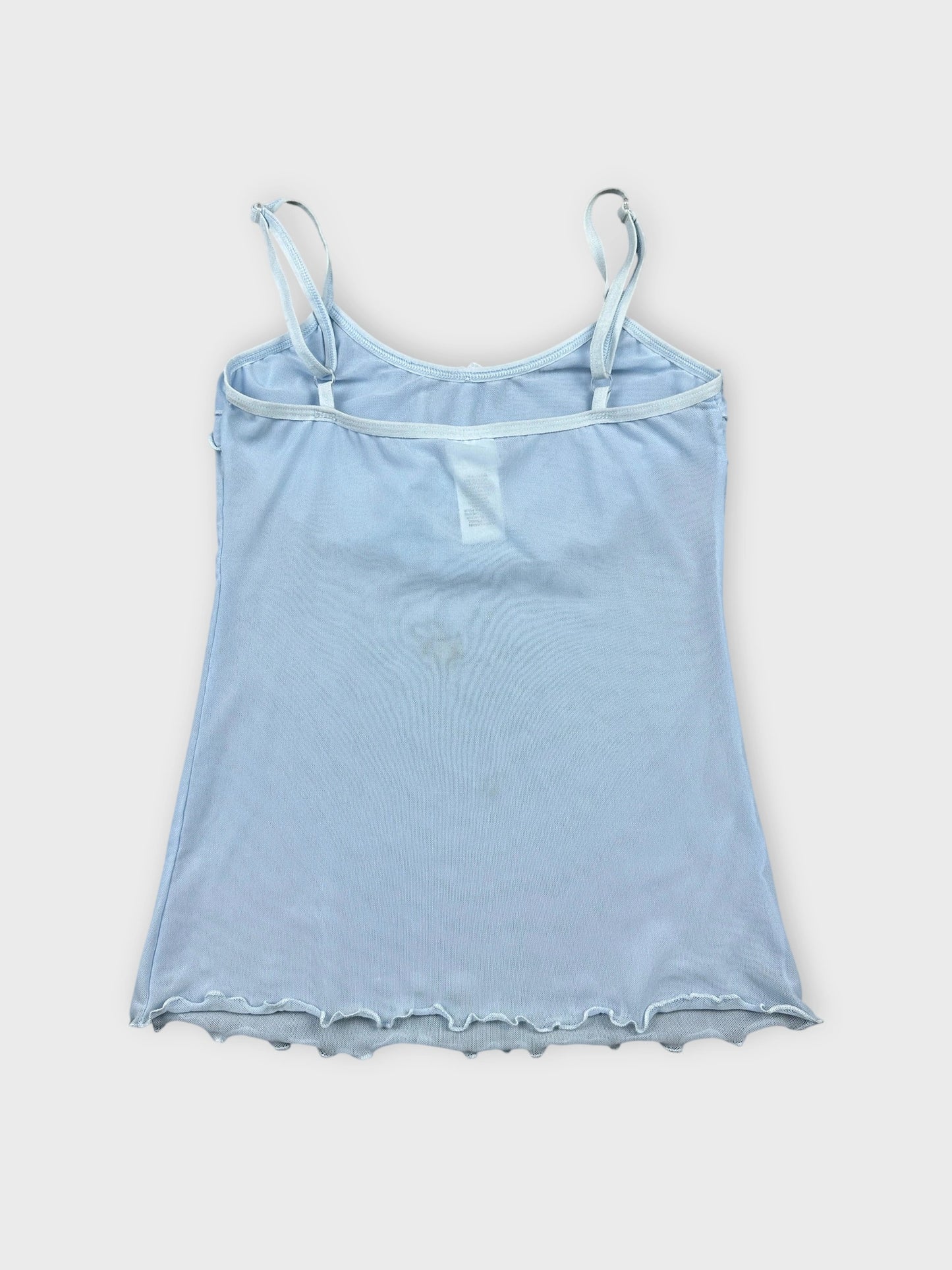 Back view of light blue camisole featuring ruffle trim at neckline.
