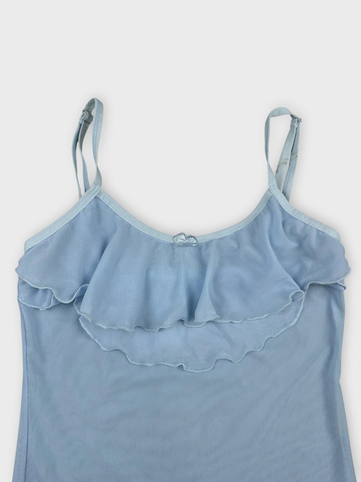 Light blue camisole with ruffle trim detail view.