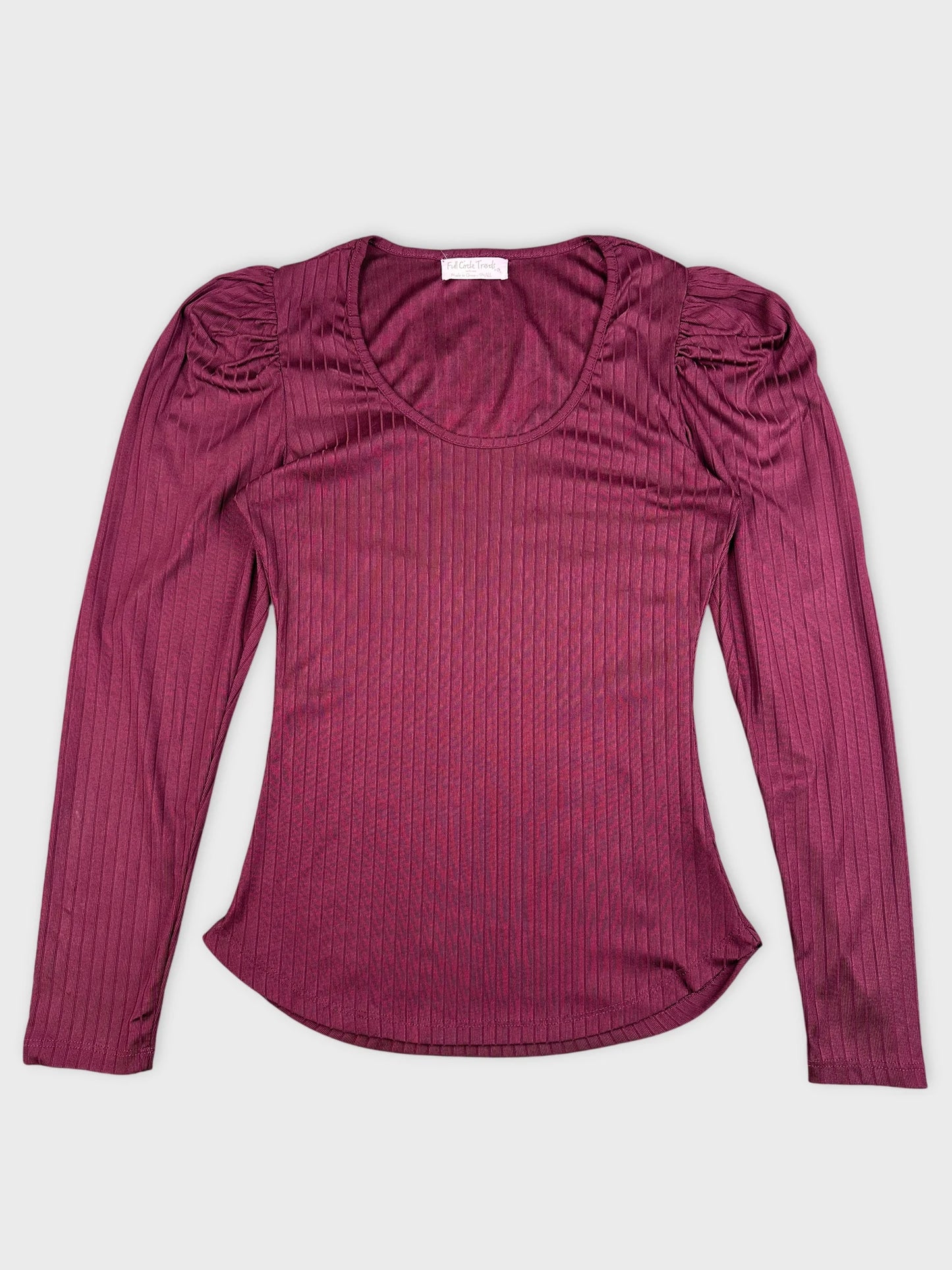 Detail view of maroon ribbed long sleeve top with puff sleeves.