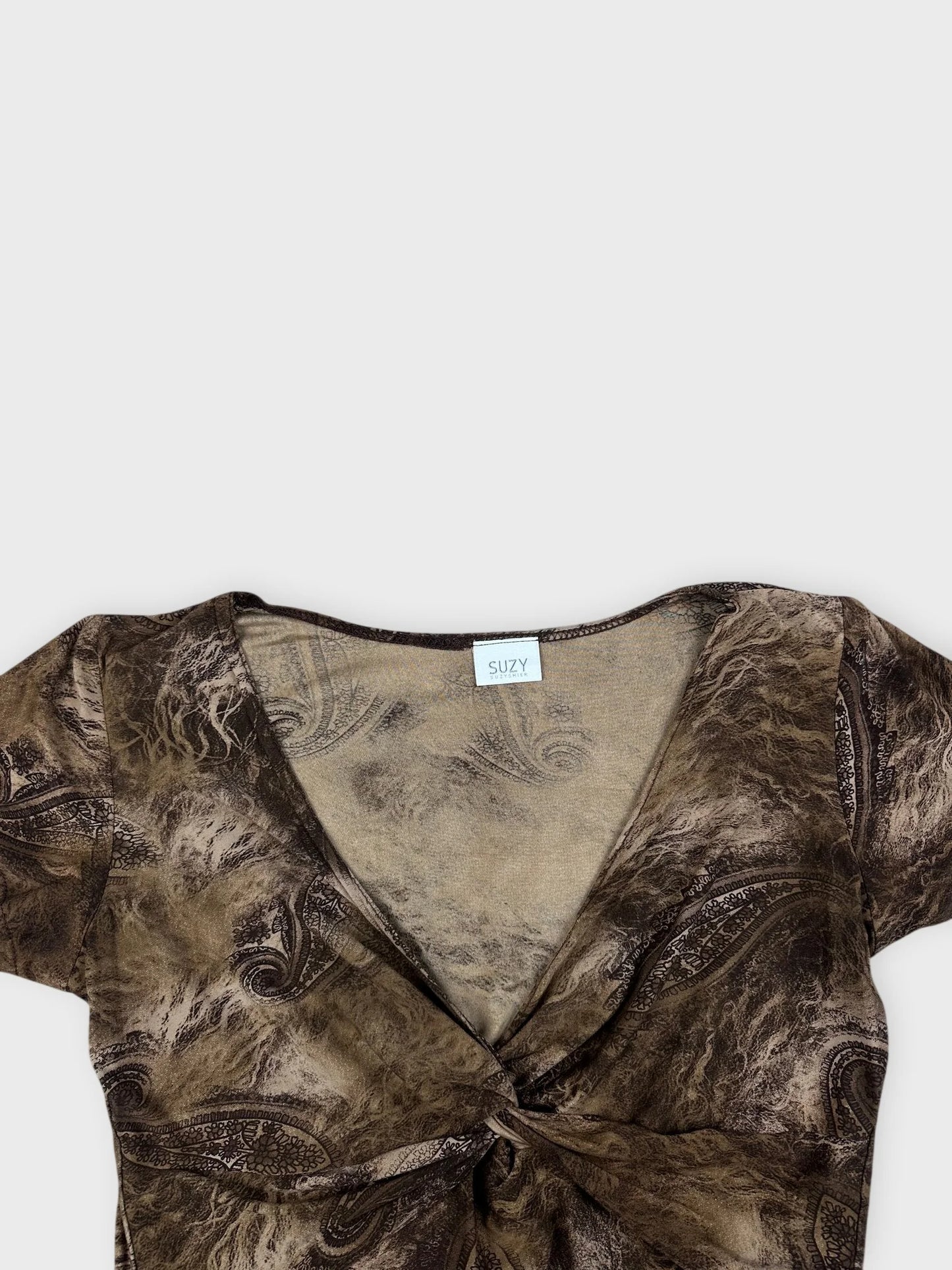 Detail view of a mesh top in brown with paisley print.
