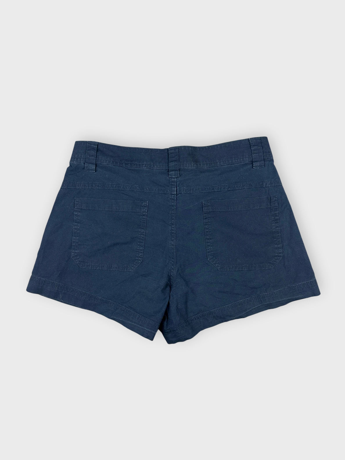 Navy cotton mini shorts back view with two pockets and neat stitching.