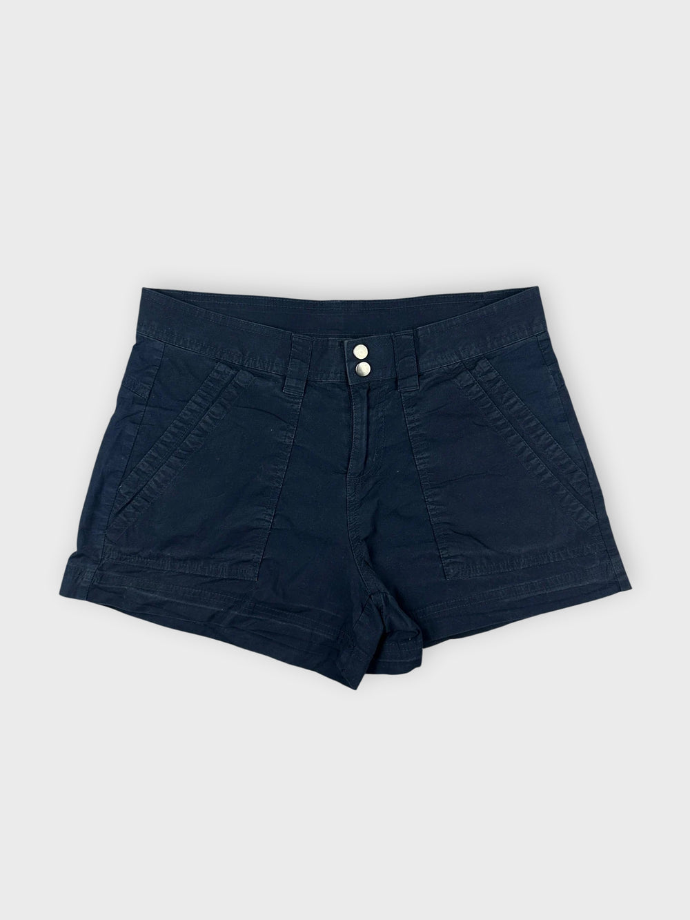 Front view of navy cotton mini shorts with sleek pockets and button details.