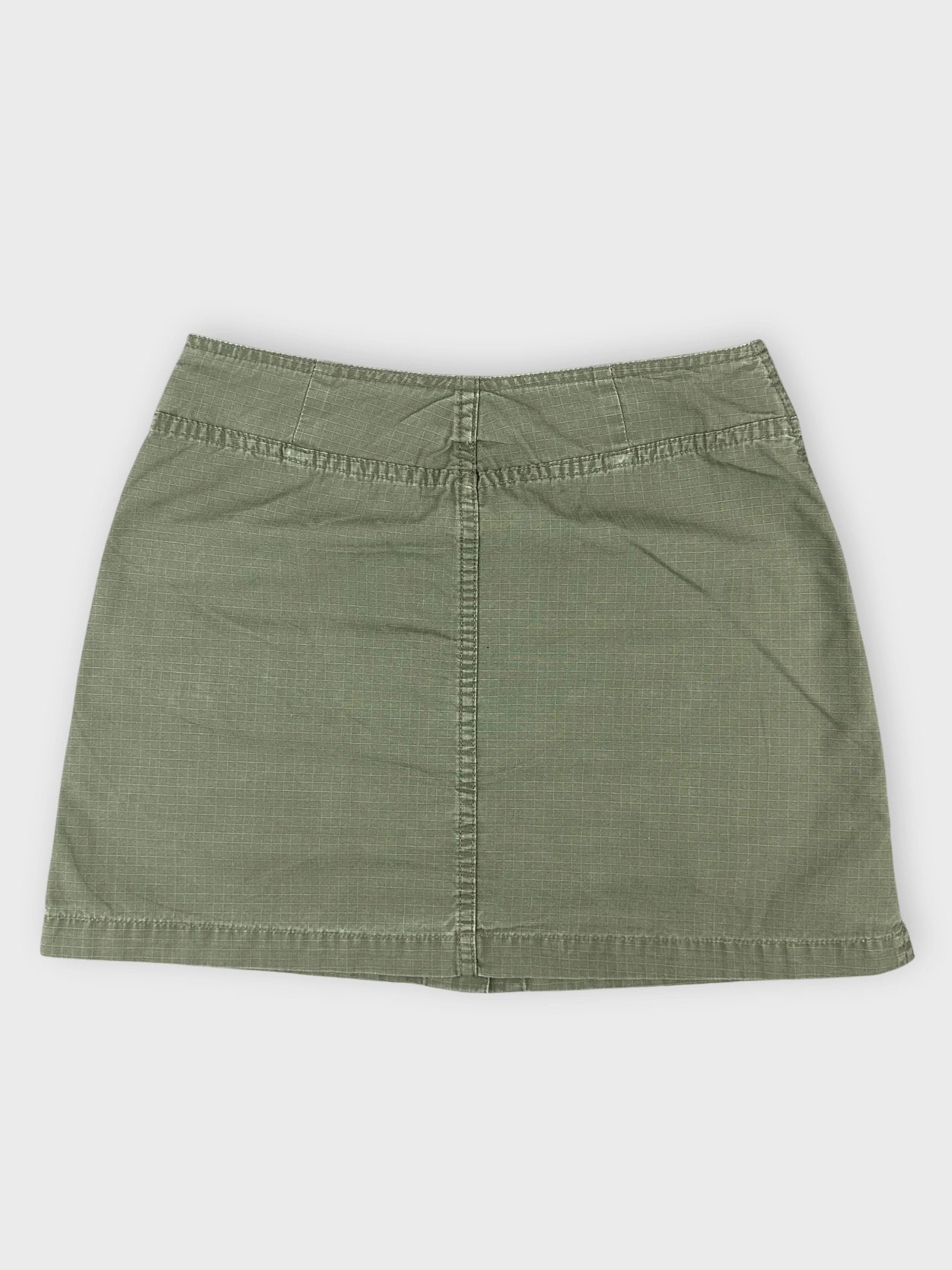 Olive mini skirt with pockets back view showing textured fabric and simple cut.