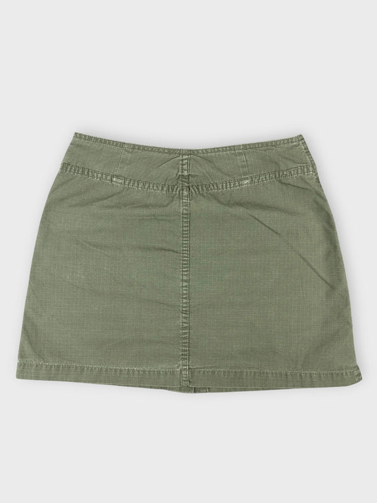 Olive mini skirt with pockets back view showing textured fabric and simple cut.