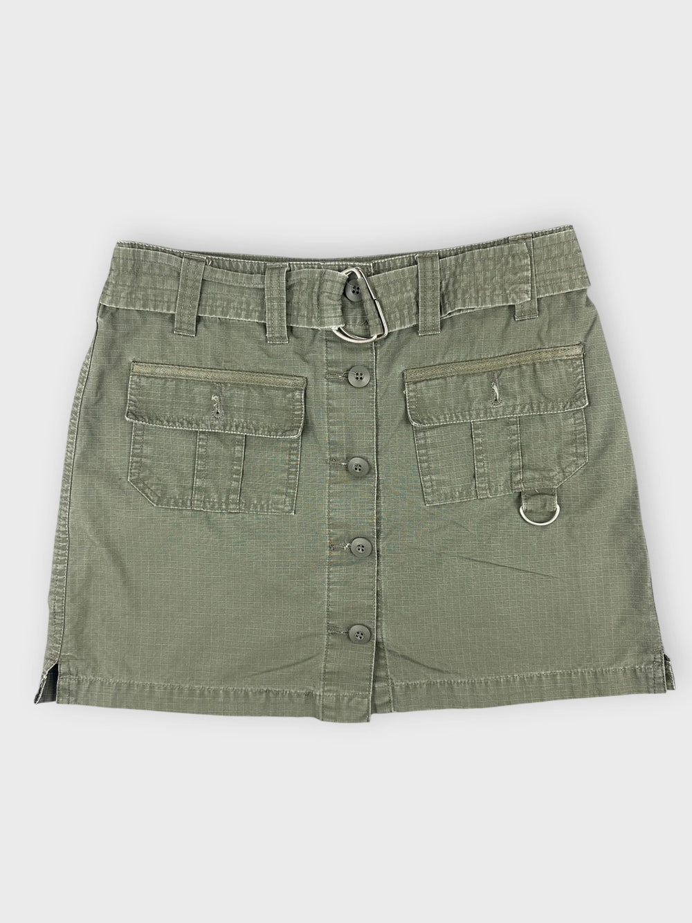 Front view of an olive mini skirt with pockets and button detail.