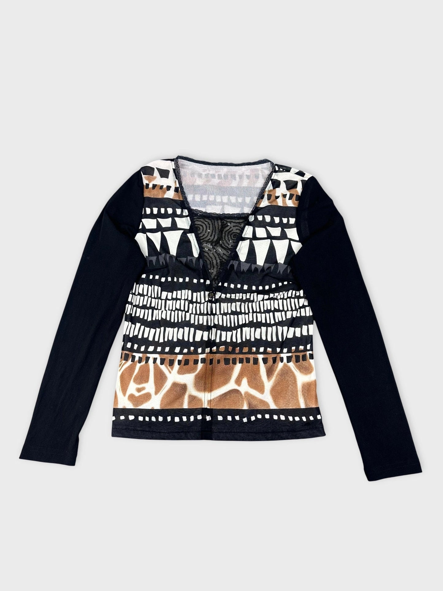 Patterned long sleeve top in black back view featuring sheer detail on neckline