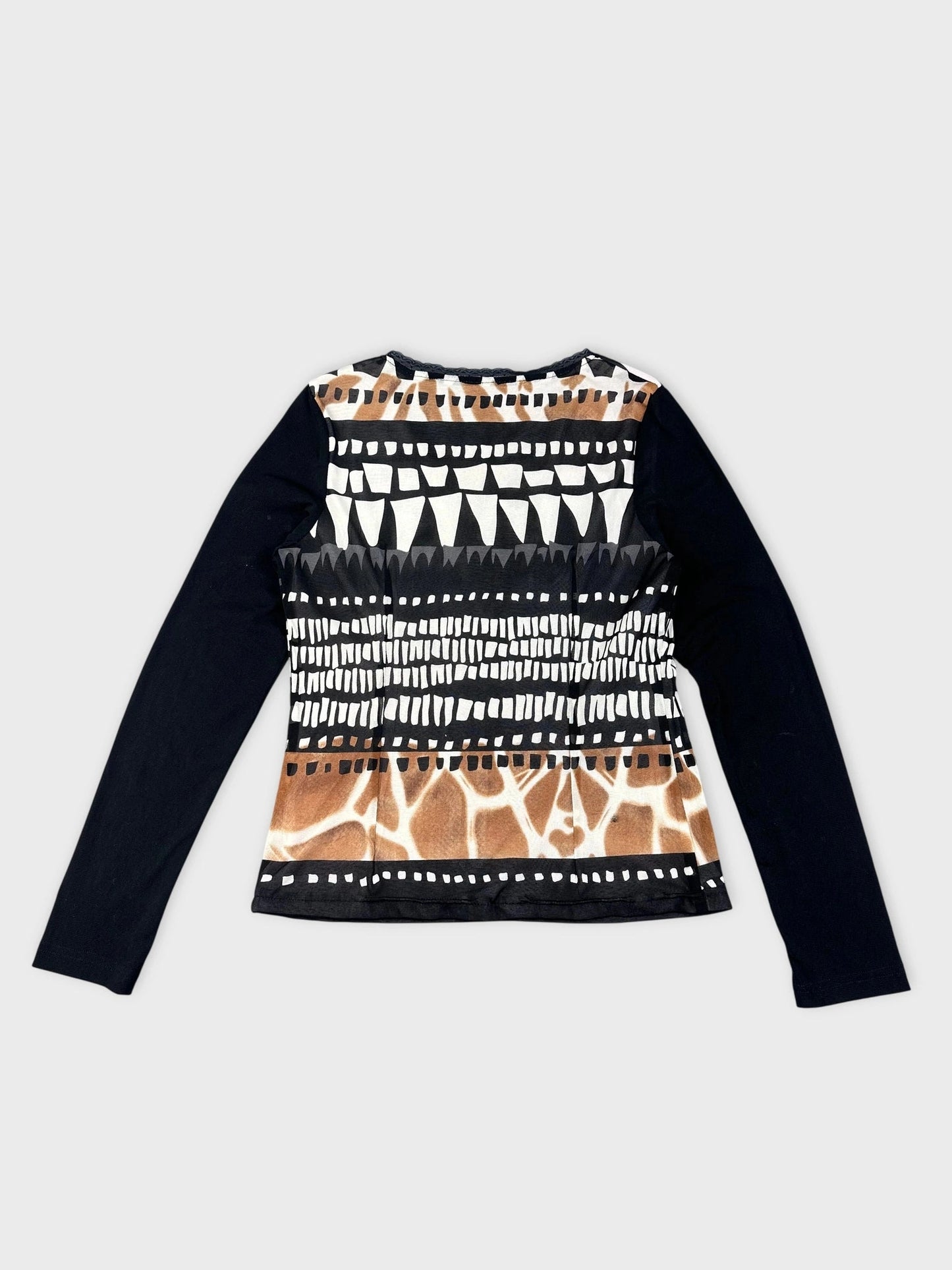 Detail view of a patterned long sleeve top featuring black and white geometric prints.