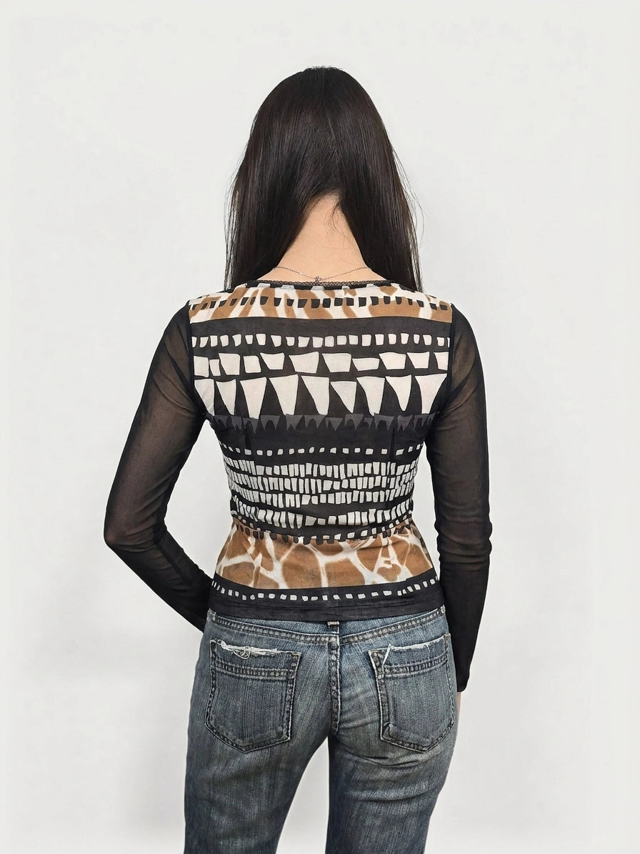 Back view of a long sleeve top in black with geometric pattern and sheer detail.