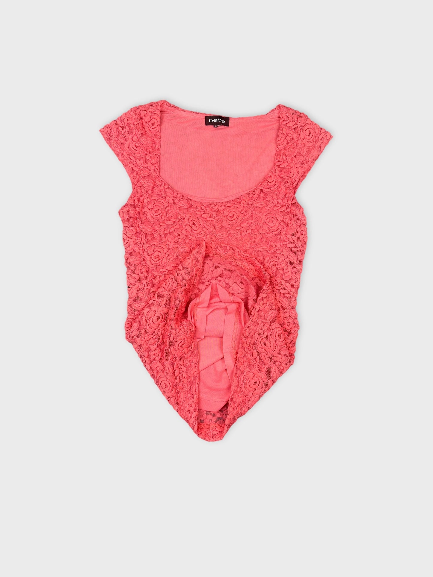 Detail view of a pink floral lace crop top with a scoop neckline.