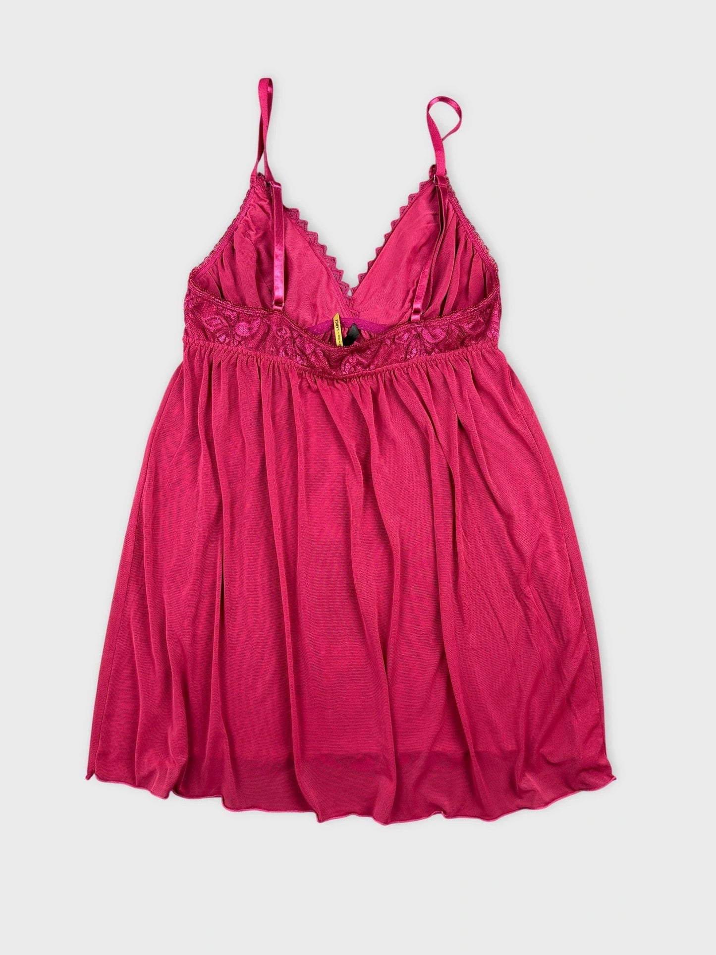 Front view of a pink lace cami featuring soft drapes and spaghetti straps.
