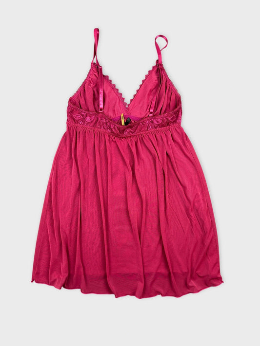 Front view of a pink lace cami featuring soft drapes and spaghetti straps.