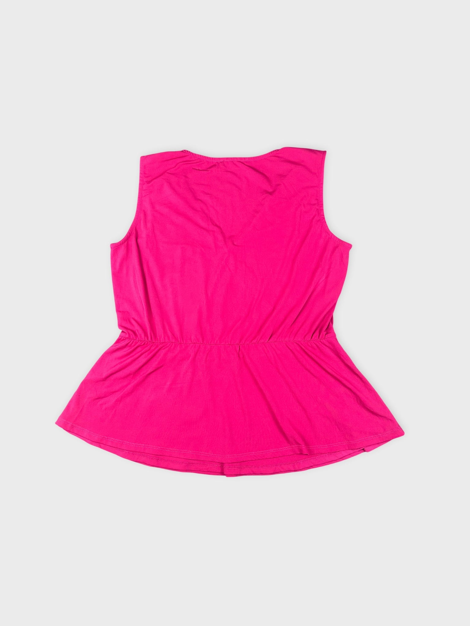Back view of a pink sleeveless top with a gathered waistline.