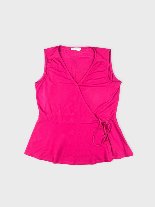 Pink sleeveless top with a wrap detail front view.