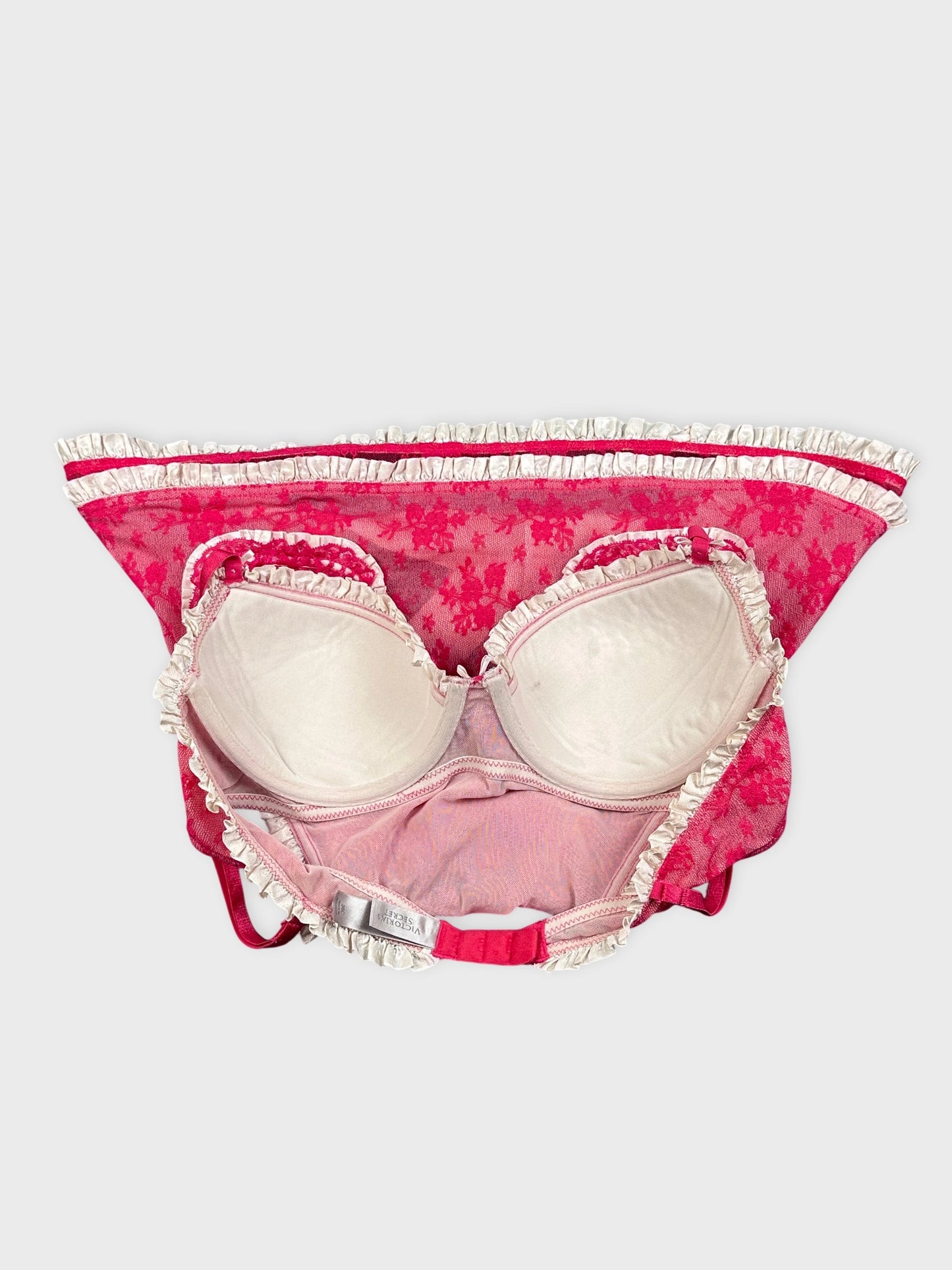 Pink bra detail view featuring floral print and ruffled trim.