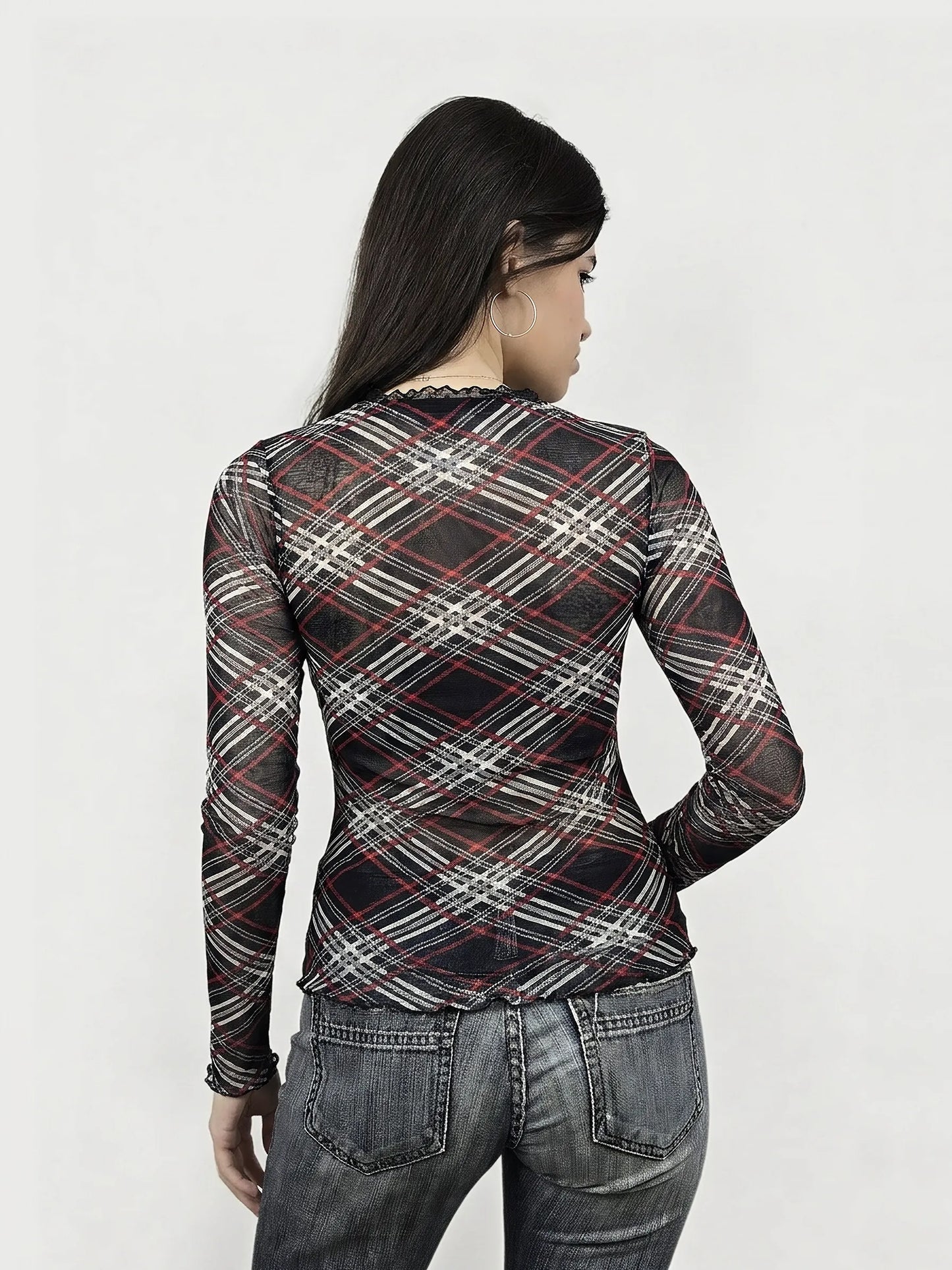Back view of a plaid mesh top with ruffled detail in black and red.