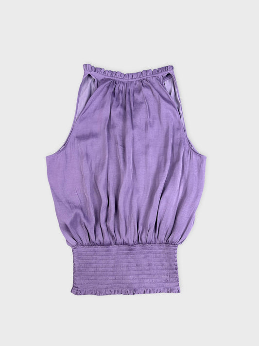 Back view of a purple balloon top featuring a smocked waist.