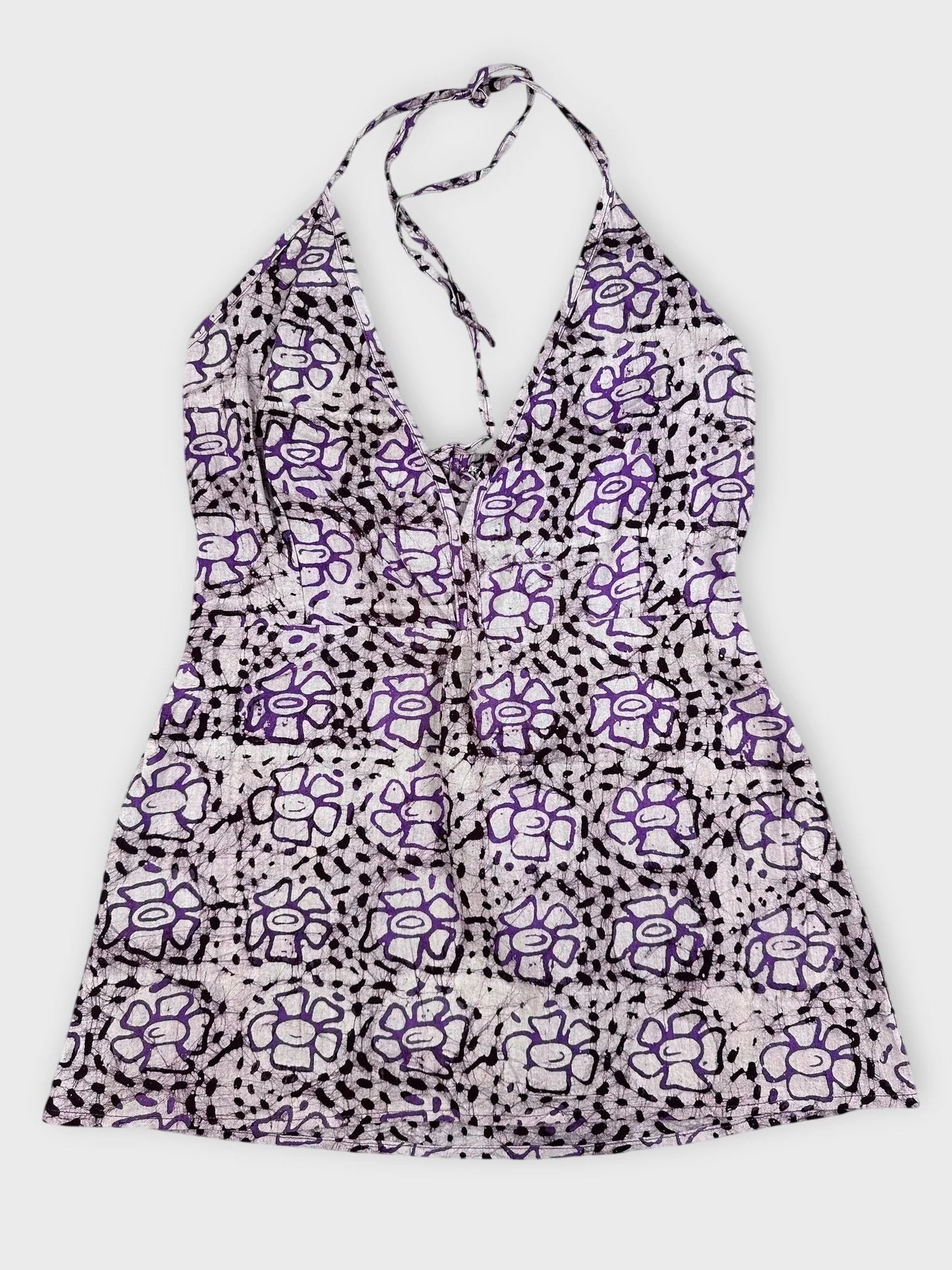 Purple floral halter top with tie detail view showing V-neckline and pattern.