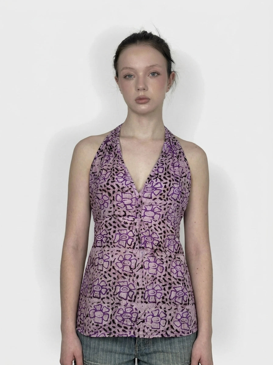 Front view of a purple floral halter top featuring a tie and intricate pattern.
