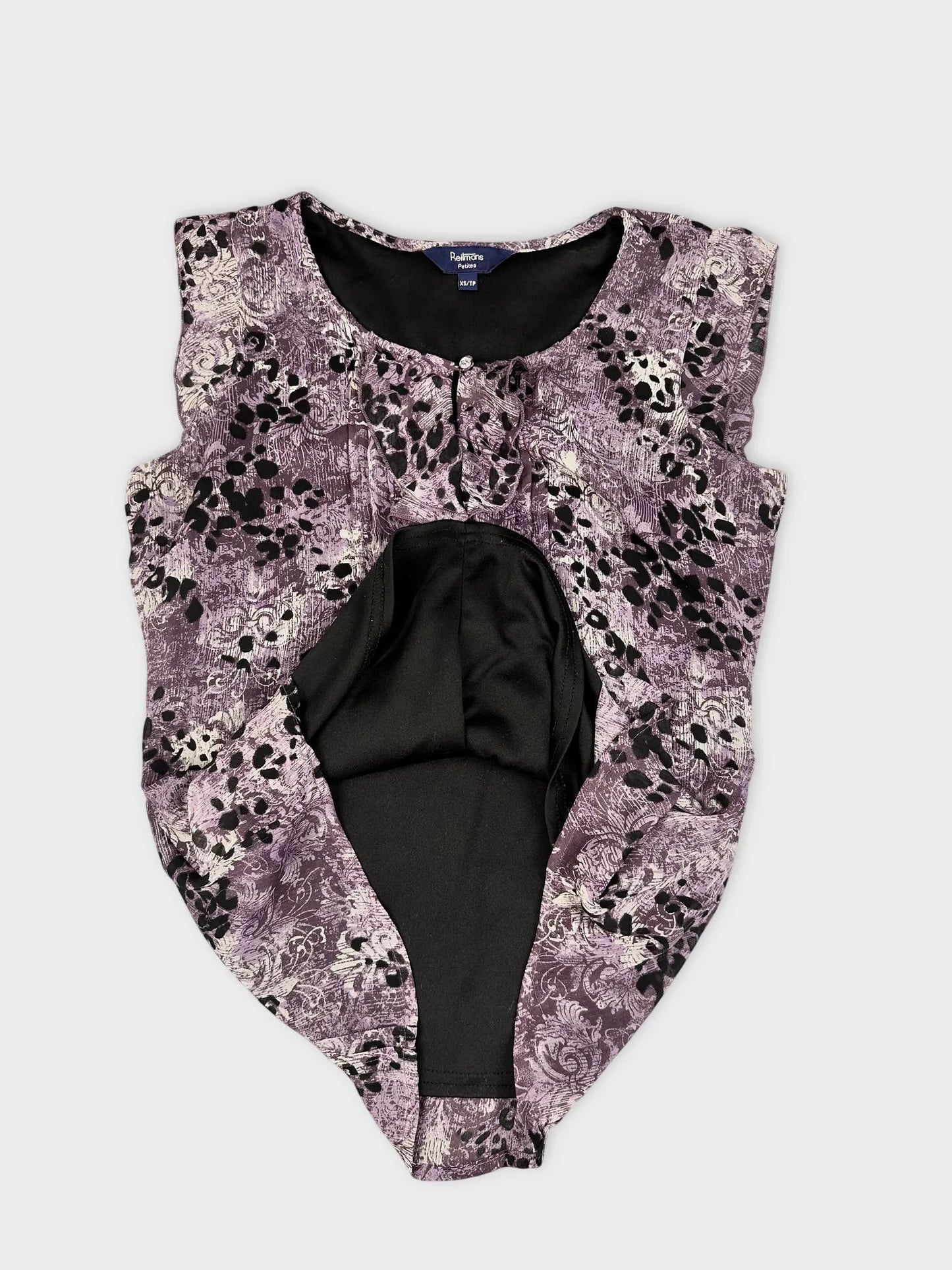 Detail view of a purple floral lace top with keyhole detail.