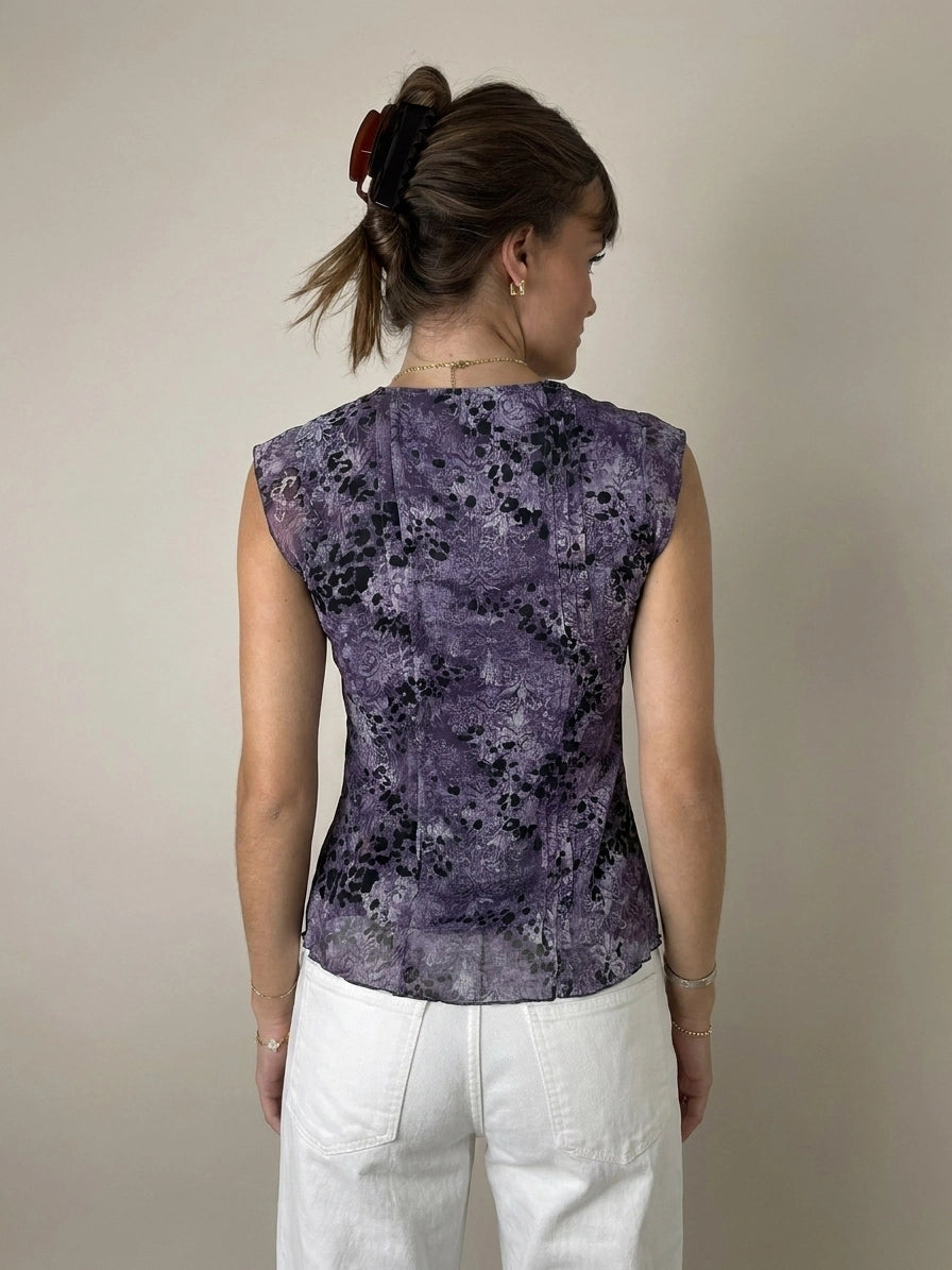 Back view of a purple floral lace top featuring a keyhole detail.