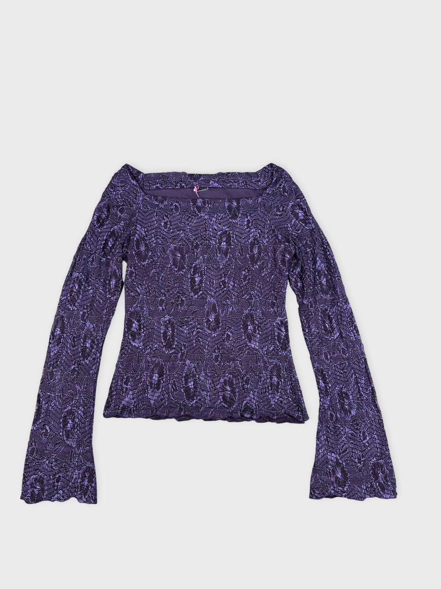 Purple lace long-sleeve crop top detail view showing floral pattern and flared sleeves.