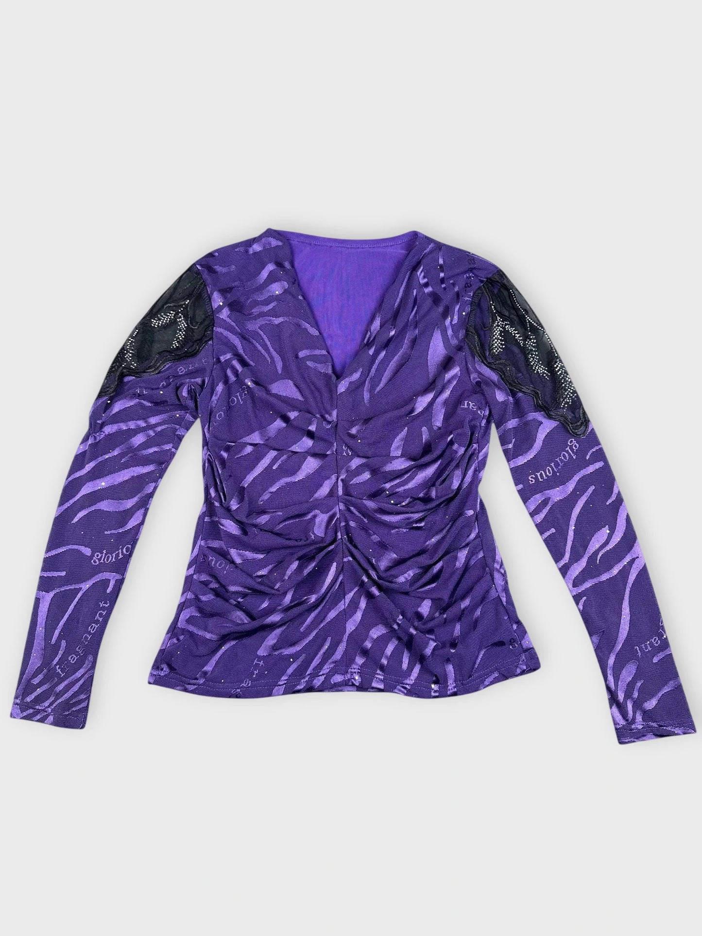 Detail view of a purple long sleeve top with zebra print and lace sleeves