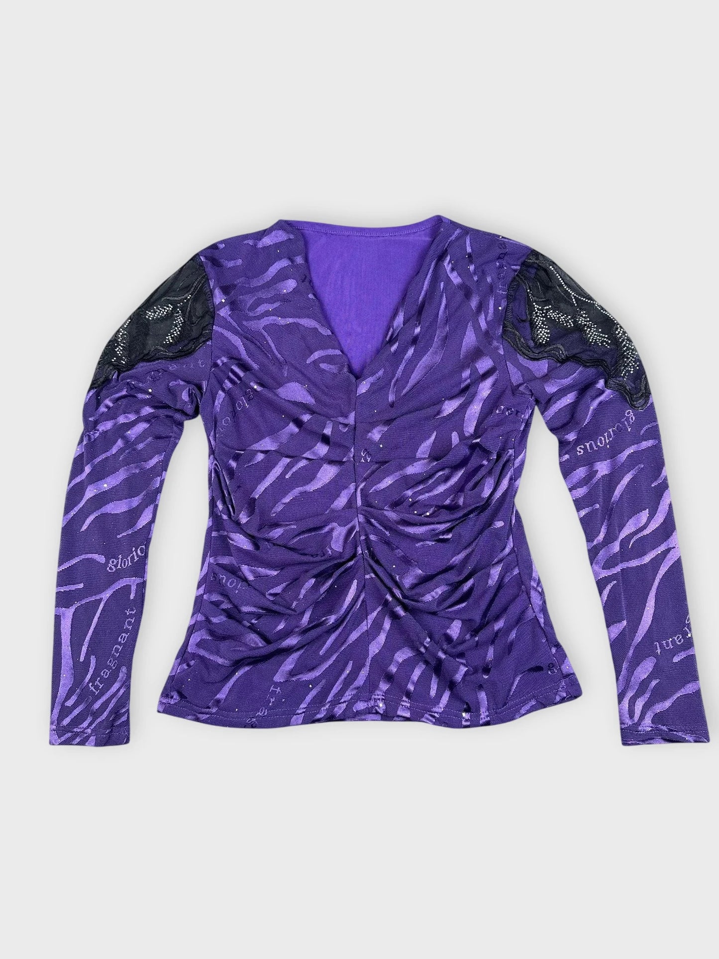 Detail view of purple long sleeve top with zebra print and lace sleeves.