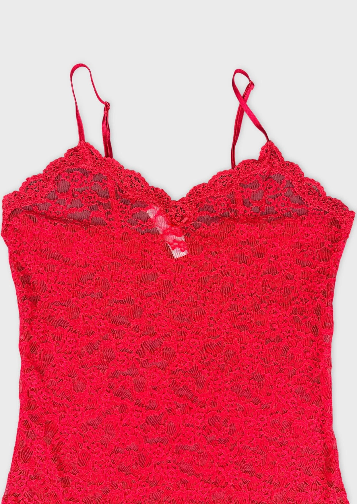 Detail view of a red lace cami top with a sweetheart neckline.