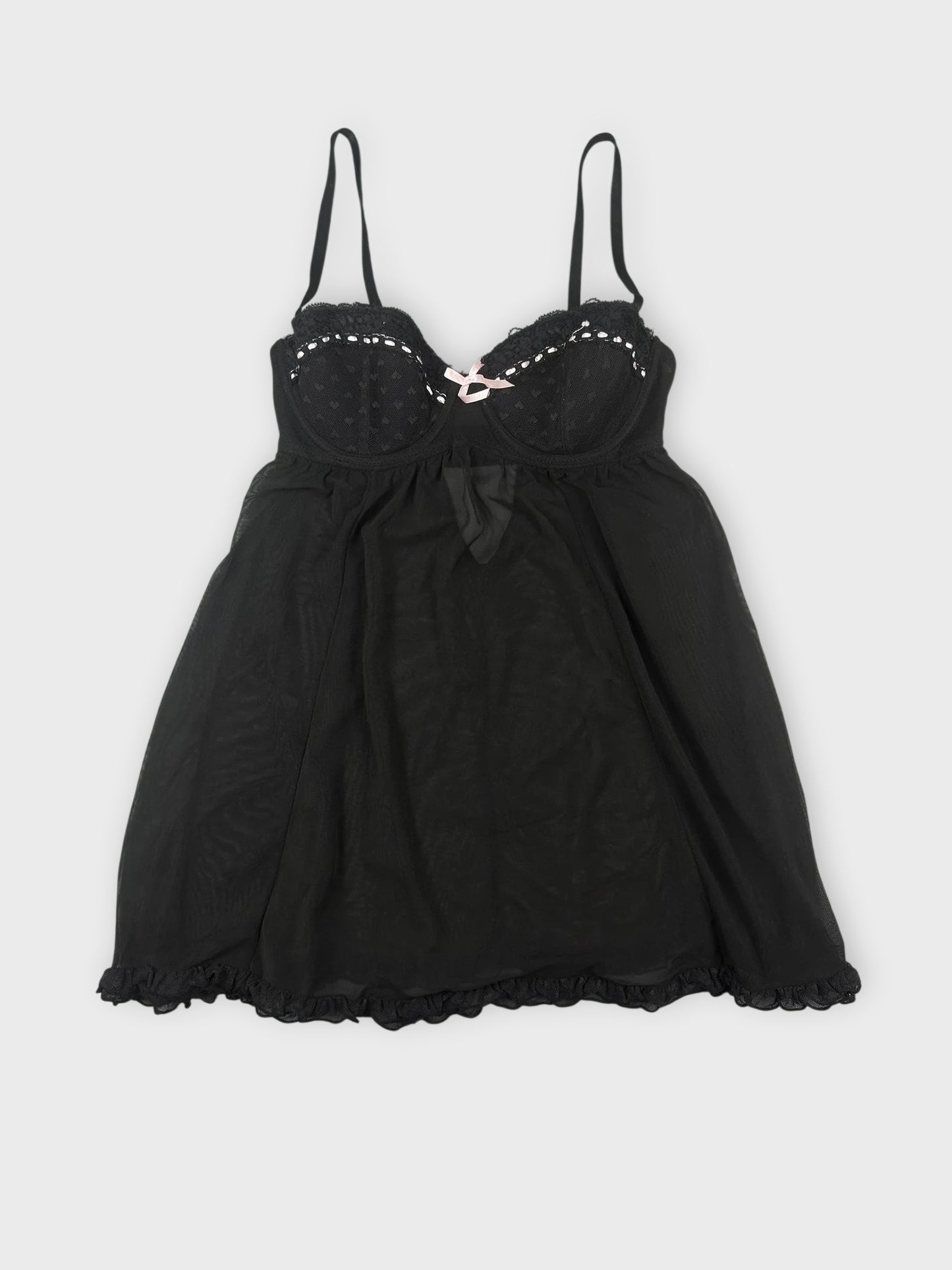 Sheer black babydoll top with pink trim front view.