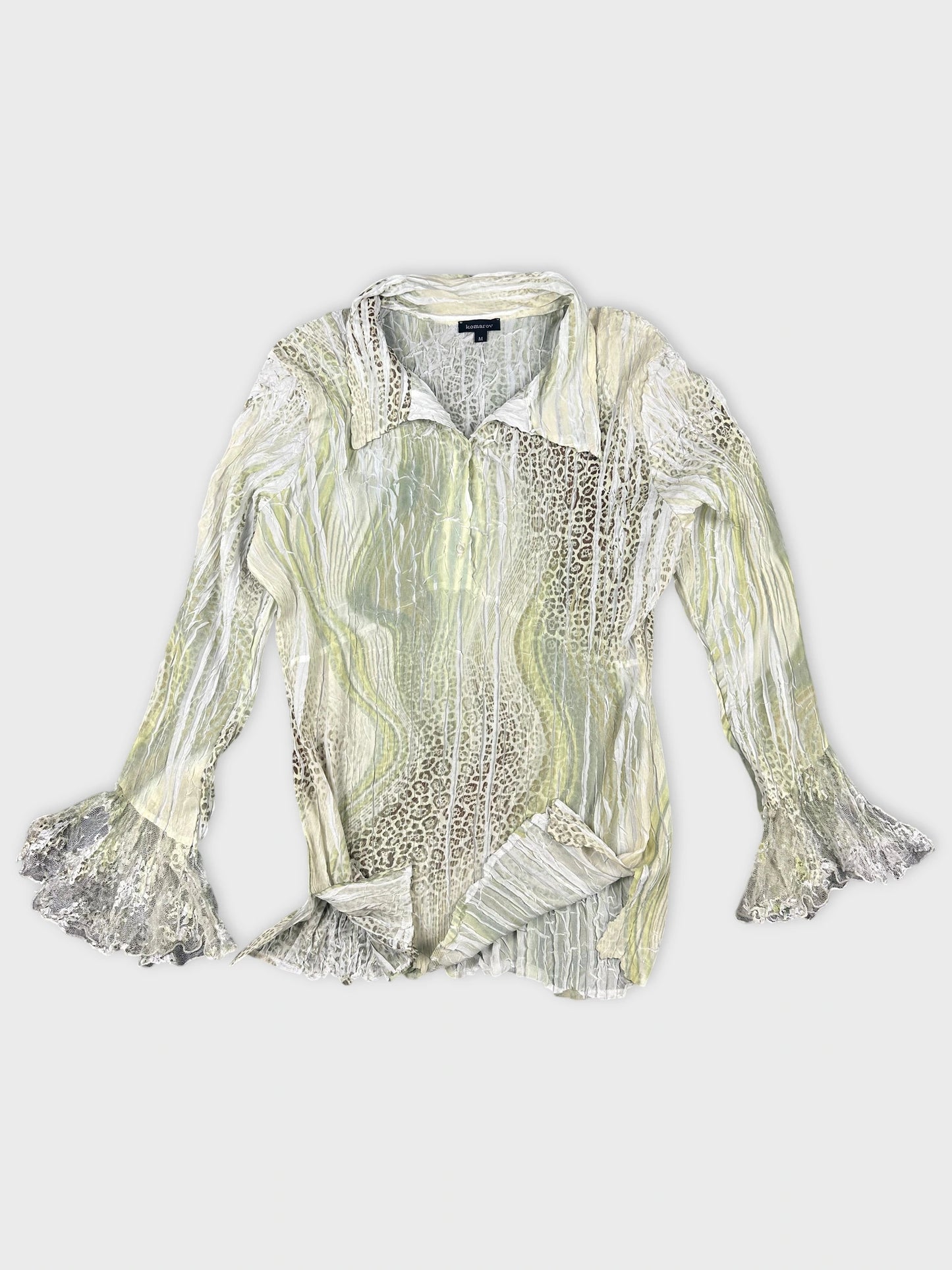 Detail view of a sheer green button-up top with lace sleeves.