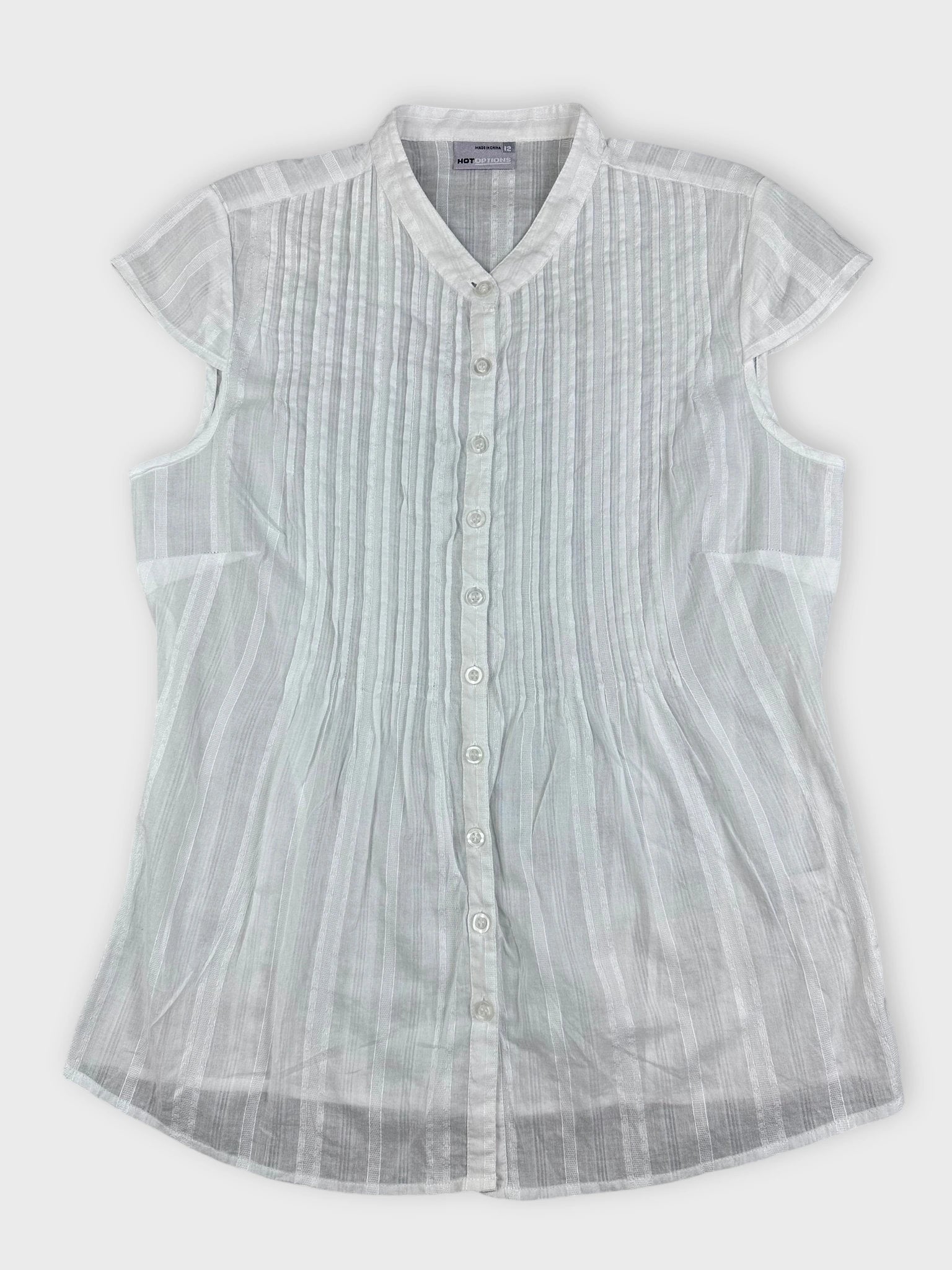 Sheer white blouse with pintuck detailing in front view.