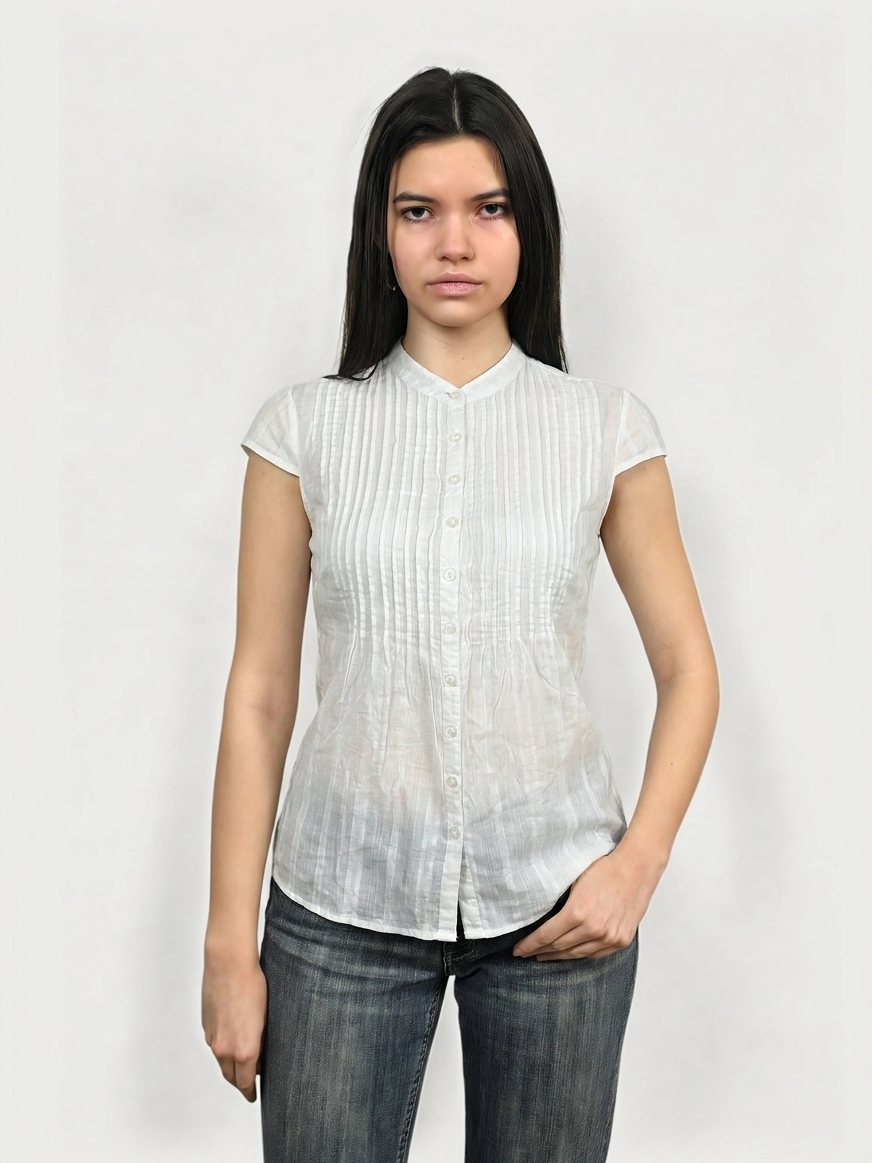 Front view of a white sheer pintuck blouse with short sleeves.