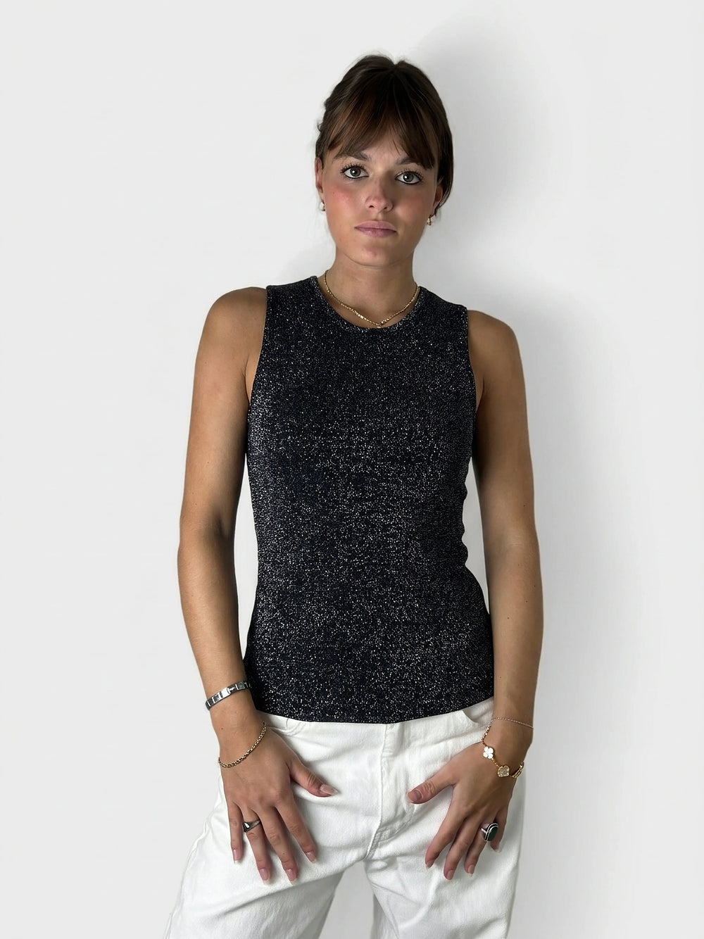 Front view of a shimmering black lurex tank top with a fitted design.