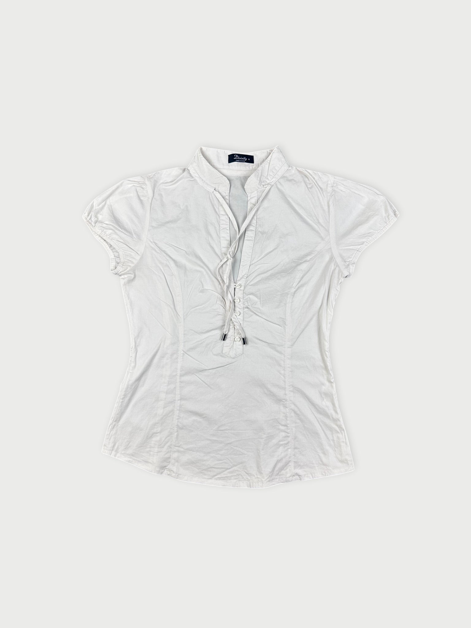 Short-sleeve white blouse with gathered detail at the neckline front view.