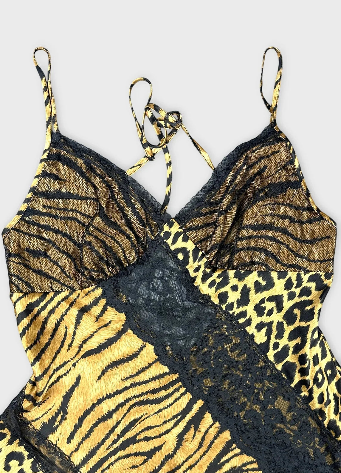 Detail view of a brown silk camisole featuring animal print and black lace trim.