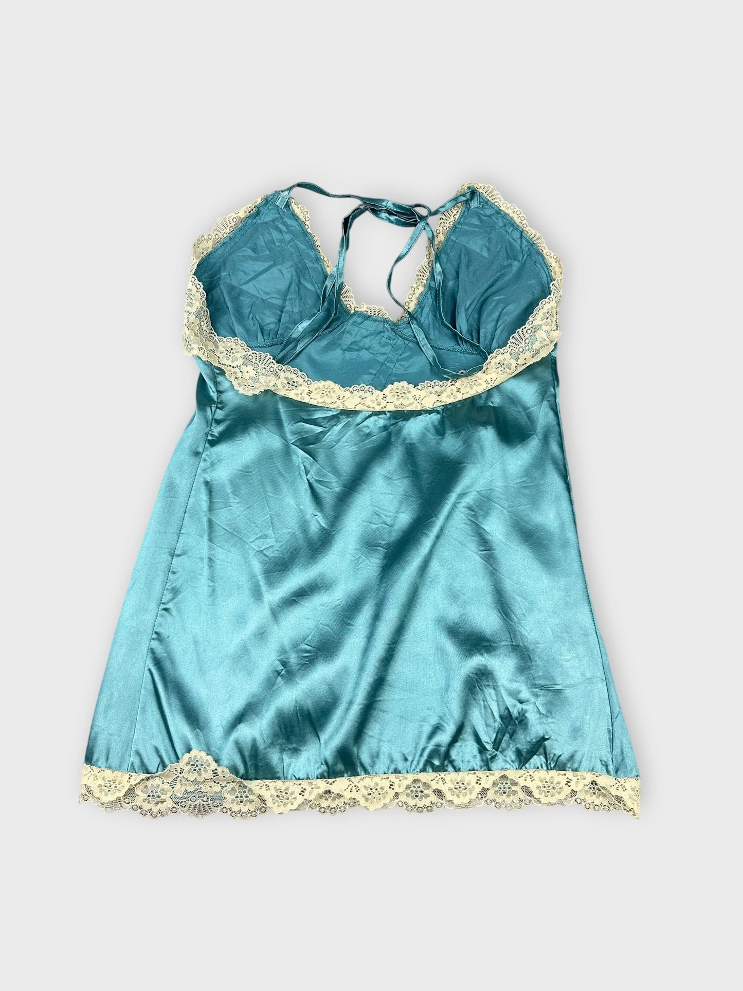 Silk blue camisole with lace trim back view showcasing delicate lace edges.