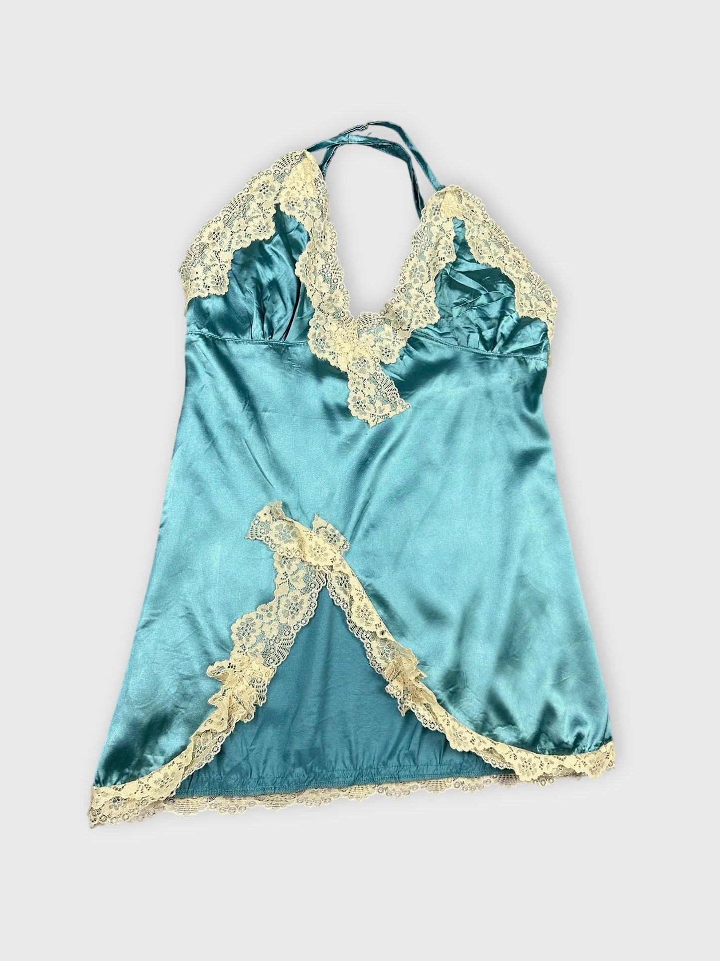 Detail view of a silk blue camisole with lace trim.