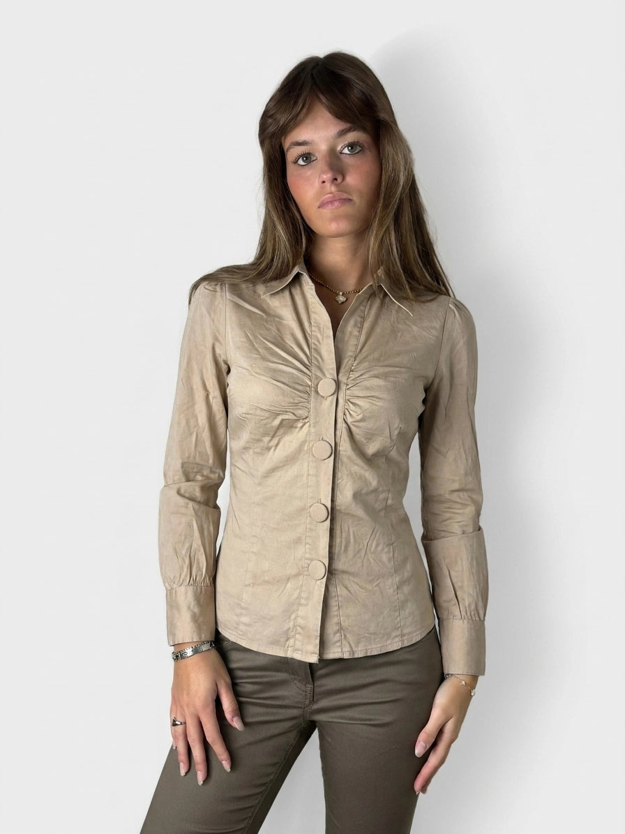 Beige button-up blouse with ruched bust, displayed in front view.